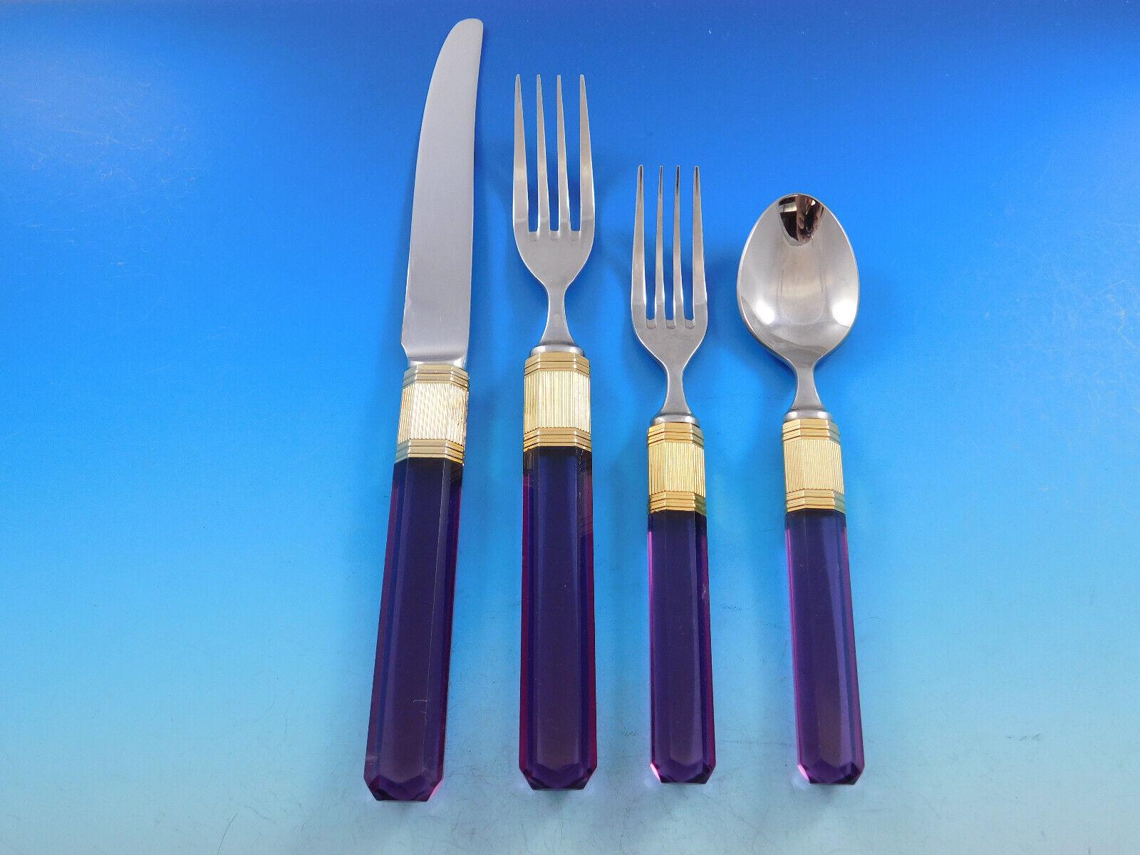 Elegant stainless steel Prisma - Amethyst by designer Larry Laslo for Mikasa - Japan, circa 1982. The handles of this set are made of lovely amethyst color Lucite with beveled edges and a prism end and gold stainless steel band accent. They reflect