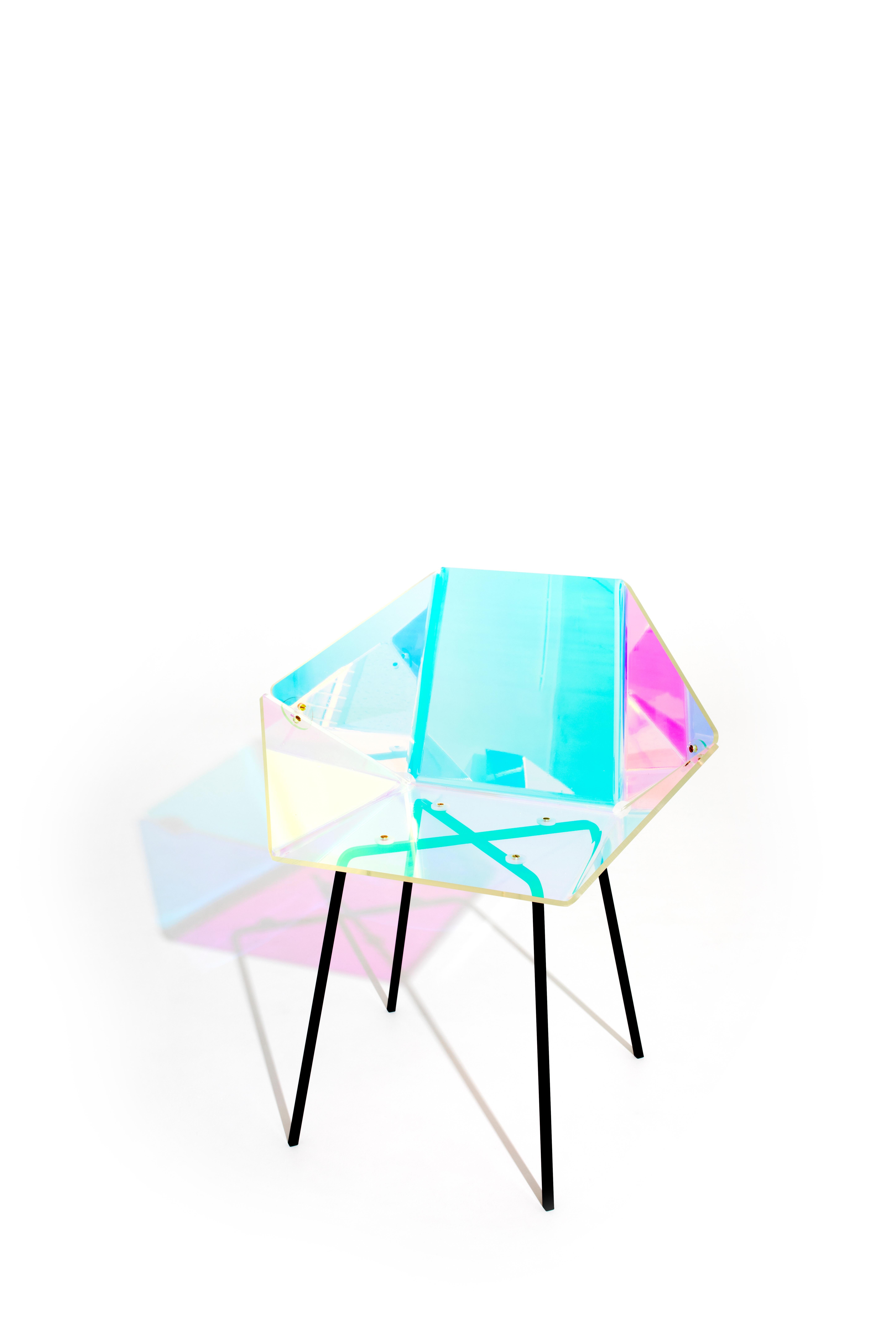 Prismania Chair Signed by Elise Luttik
Dimensions: D 48.5 x W 70 x H 79 cm
Materials: Polycarbonate transparent shell with a prismatic polyester film, steel, epoxy.
Also available with white base.

The transparent Prismania Chair is both an artefact