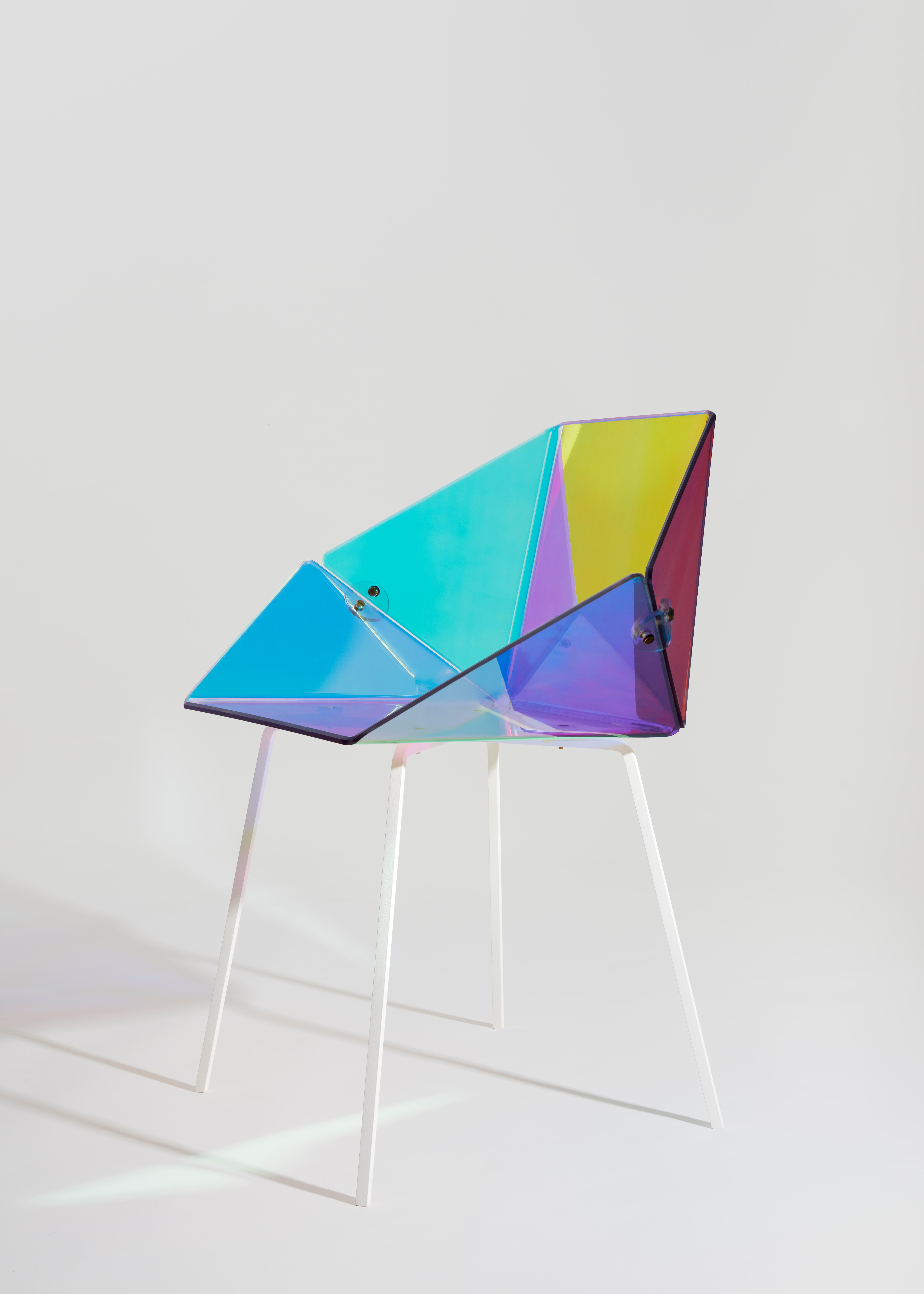Prismania chair signed by Elise Luttik
Dimensions: D 48.5 x W 70 x H 79 cm
Materials: Polycarbonate transparent shell with a prismatic polyester film, steel, epoxy.
Also available with black base.

The transparent Prismania chair is both an artefact