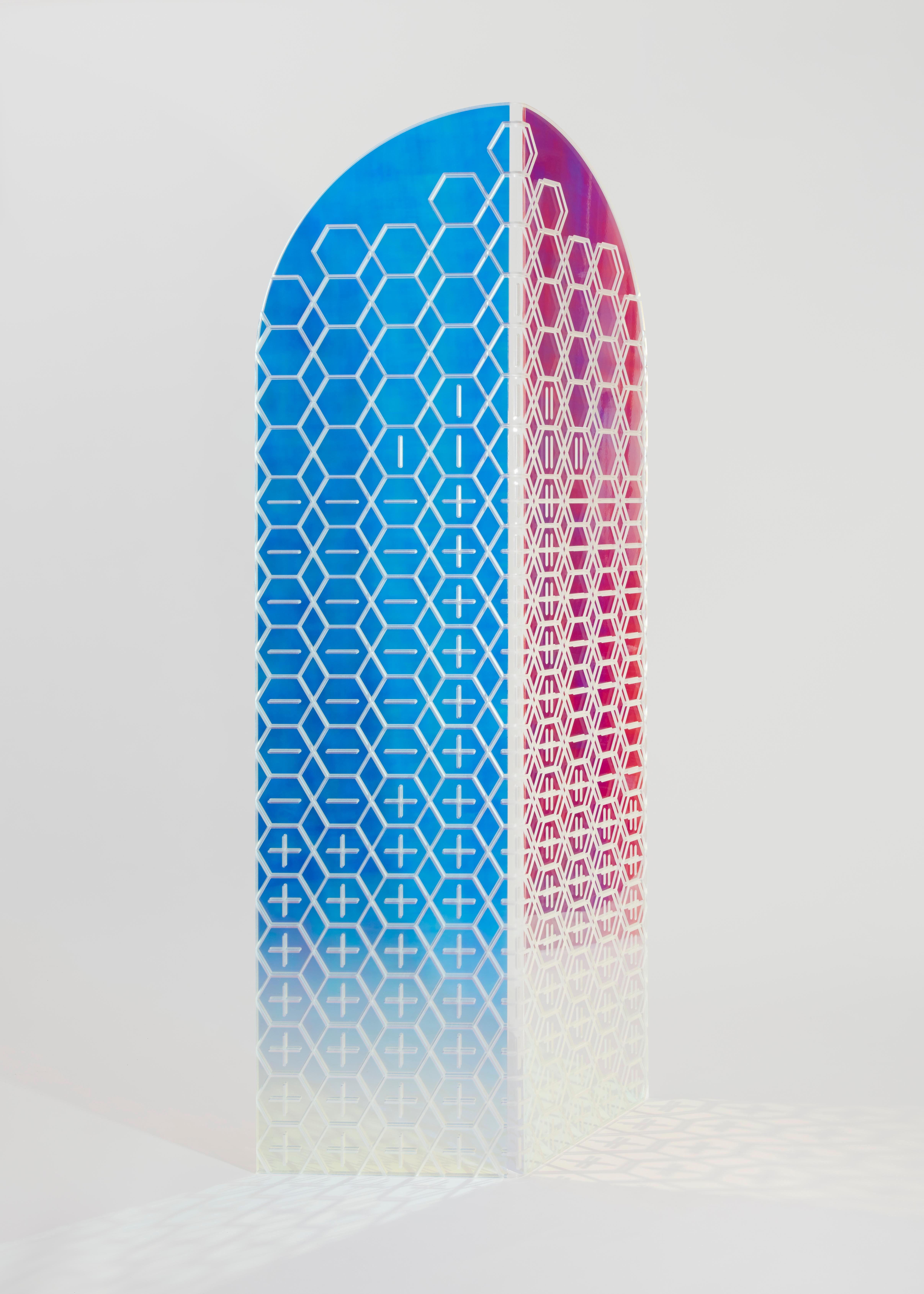 Prismania room divider by Elise Luttik
Limited Edition
Dimensions: D 21 x W 70 x H 165 cm
Materials: Acrylic with dichroic film.

The screen is topped by arches. To Elise Luttik the arches embody a door to a different world. The transparent screen