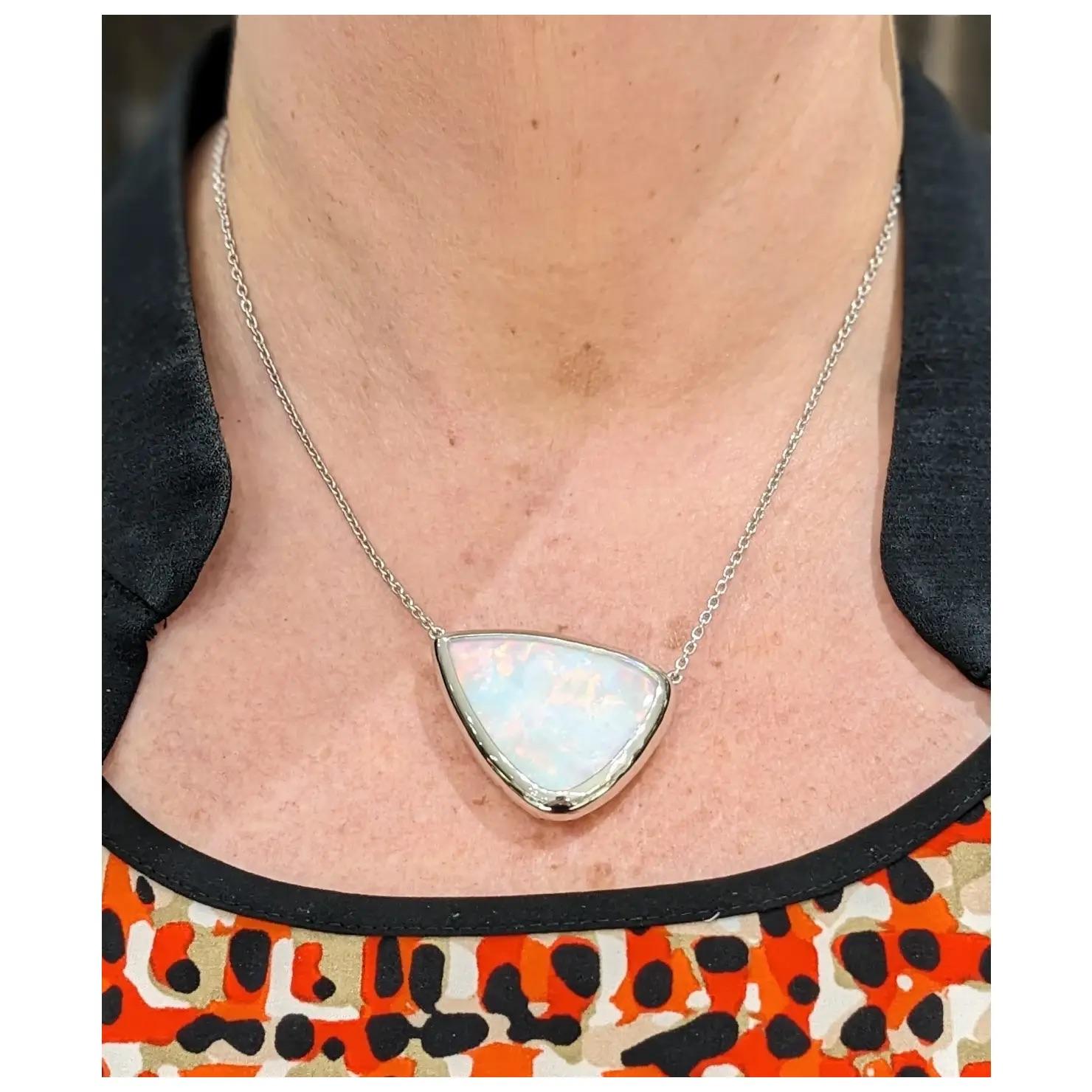 Prismatic 55.32ct Brazilian Opal Modern Pendant Necklace

Presenting a luminous 55.32ct Brazilian Opal pendant necklace, intricately set in 14k white gold. This modern piece showcases a dazzling pear-shaped Brazilian Opal, glowing with unmatched