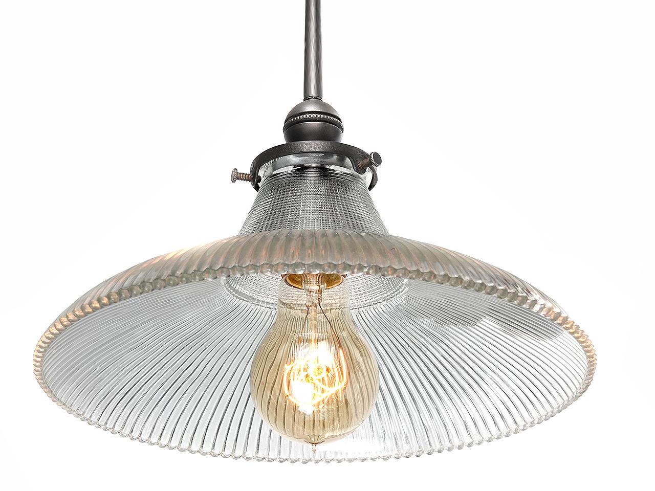 This is a nice simple Prismatic pendent. Prismatic glass gives the off a nice warm glow and can feel early and modern at the same time. This example features a 10 in diameter shade. We have a good collection of these priced per lamp.