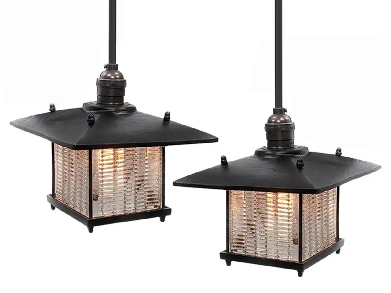 This pendent has a Frank Lloyd Wright feel. The long overhang on the shade has a strong architectural look and goes well with the louvered prismatic glass. The brass is a heavy cast and feels rich. The glass was inspired by early industrial Luxfer