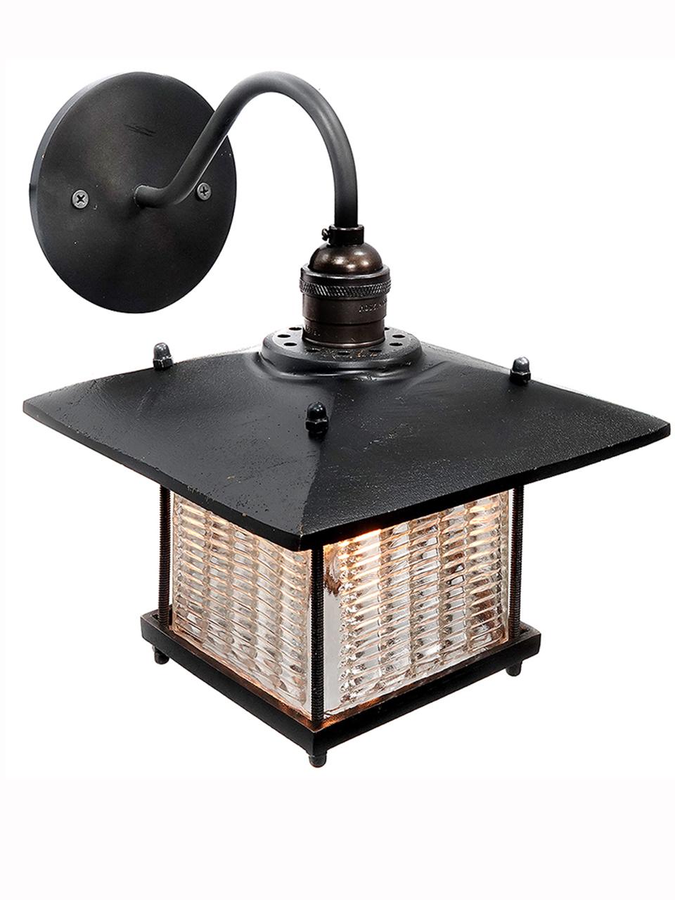 This sconce has a Frank Lloyd Wright feel. The long overhang on the shade has a strong architectural look and goes well with the louvered prismatic glass. The brass is a heavy cast and feels rich. The glass was inspired by early industrial Luxfer