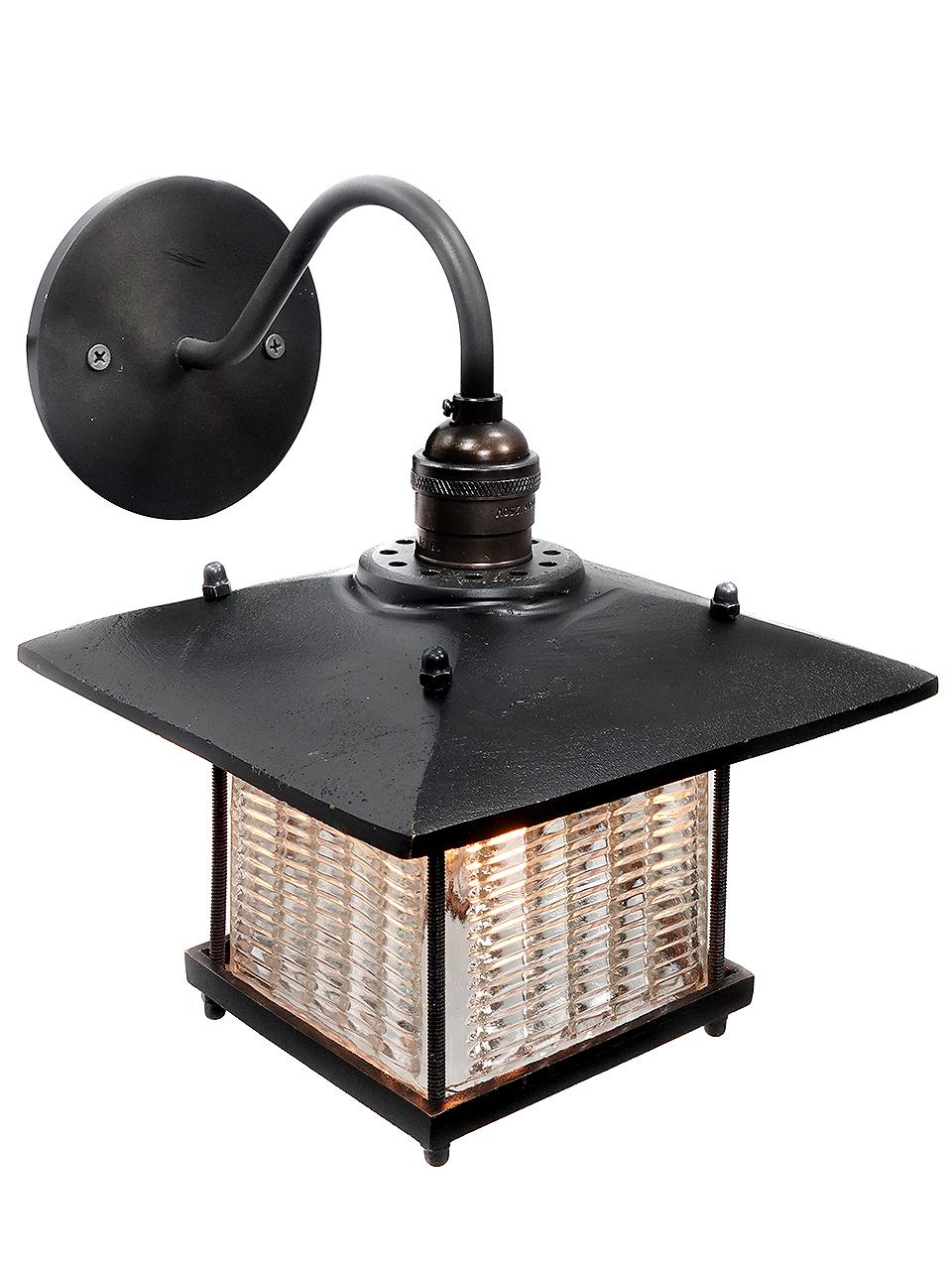 This sconce has a Frank Lloyd Wright feel. The long overhang on the shade has a strong architectural look and goes well with the louvered prismatic glass. The brass is a heavy cast and feels rich. The glass was inspired by early industrial Luxfer