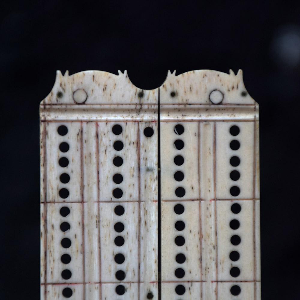 We are proud to offer a mid-19th century Prisoner of War (POW) handmade cow bone cribbage board. With a sliding draw section under its base (excluding cribbage counters) this item is well formed and a mark of great craftmanship. With individually