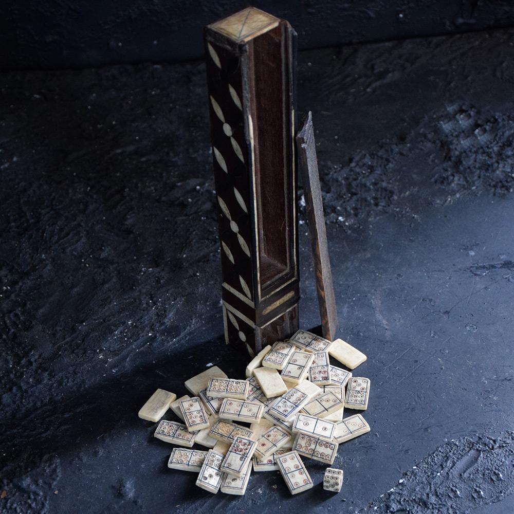 Prisoner of War Domino and dice set 

This set is made from cow bone. Hand carved in the 19th Century by a prisoner of war. The 49 pieces of dominos and single dice are encased in a sliding top box covered in bone and wood patterns. The sliding