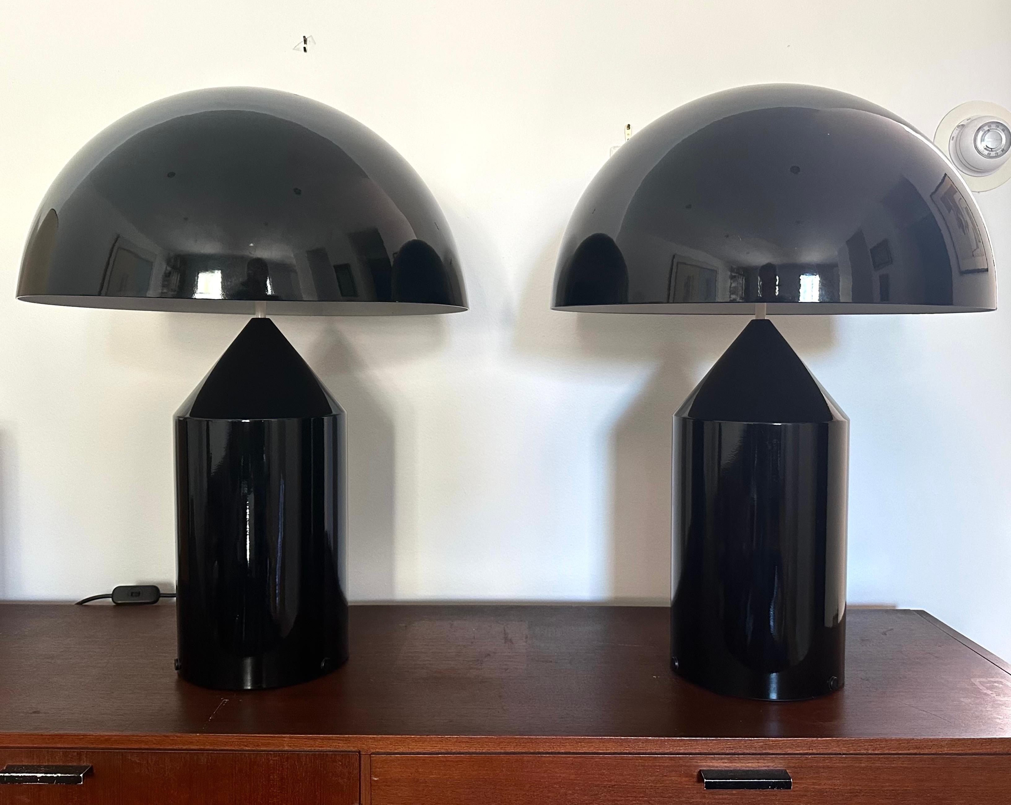 Vico Magistretti Introduced the Atollo lamp in 1979, and it has become one of the most iconic designs of Italian lighting.  Sculptural, sleek and fun, the lamp also provides beautiful diffused light. This pristine pair in black enamel is the model