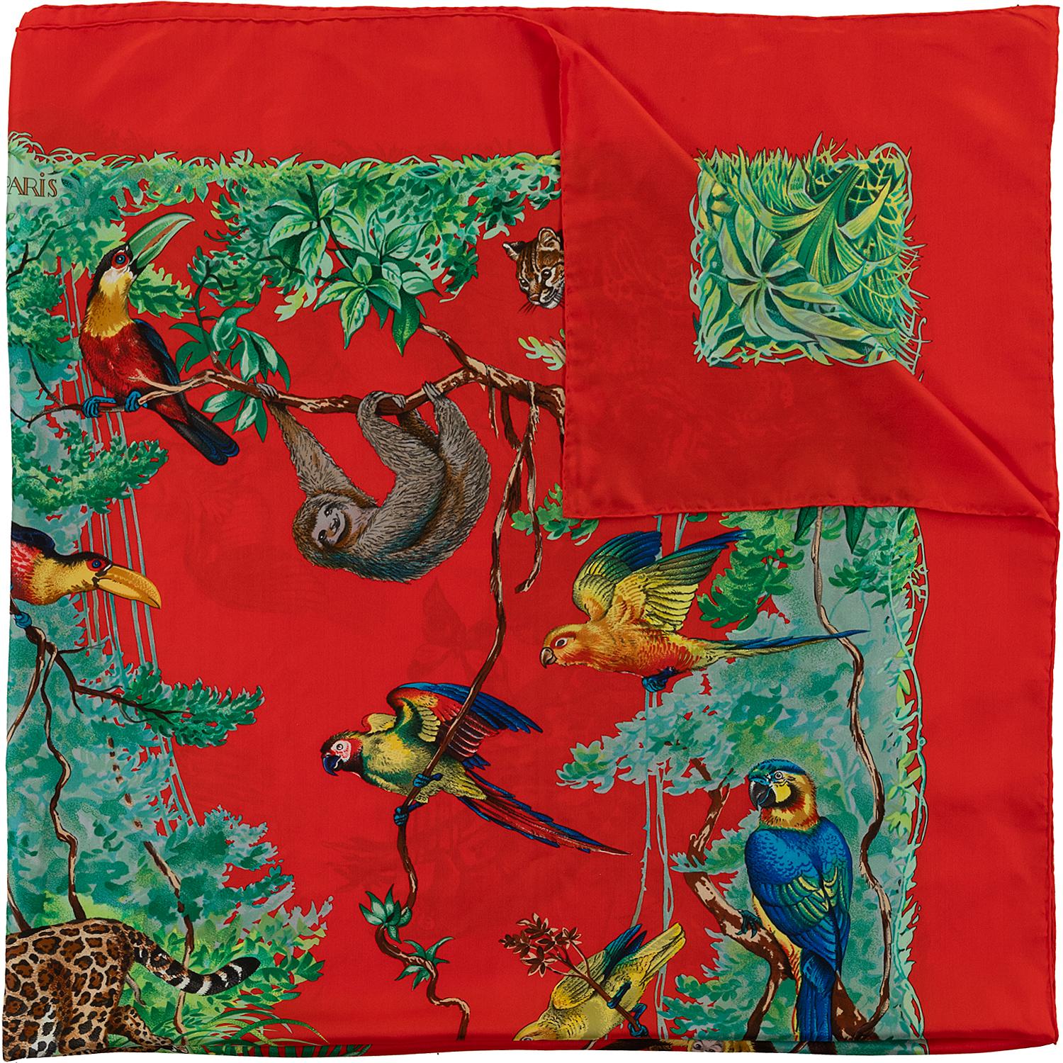 'Equateur' first designed by Robert Dallet in 1988, is a wonderfully evocative Hermes Silk Shawl with vibrant colours on a red ground, depicting animal-life at the equator. The 140cm (55in. x 55in.) Shawl comes with it's original Hermes sales Tag