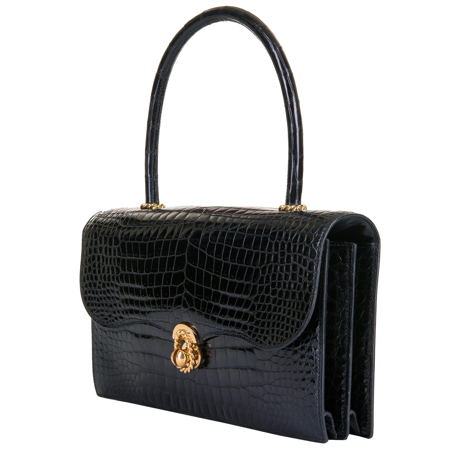 In pristine condition, inside and out, this Beautiful Hermes Vintage Handbag is finished in Black Shiny Porosus Crocodile, accented with Gold 'Cordeliere' Hardware. The rigid design of the bag & handle, means it has retained it's original shape and
