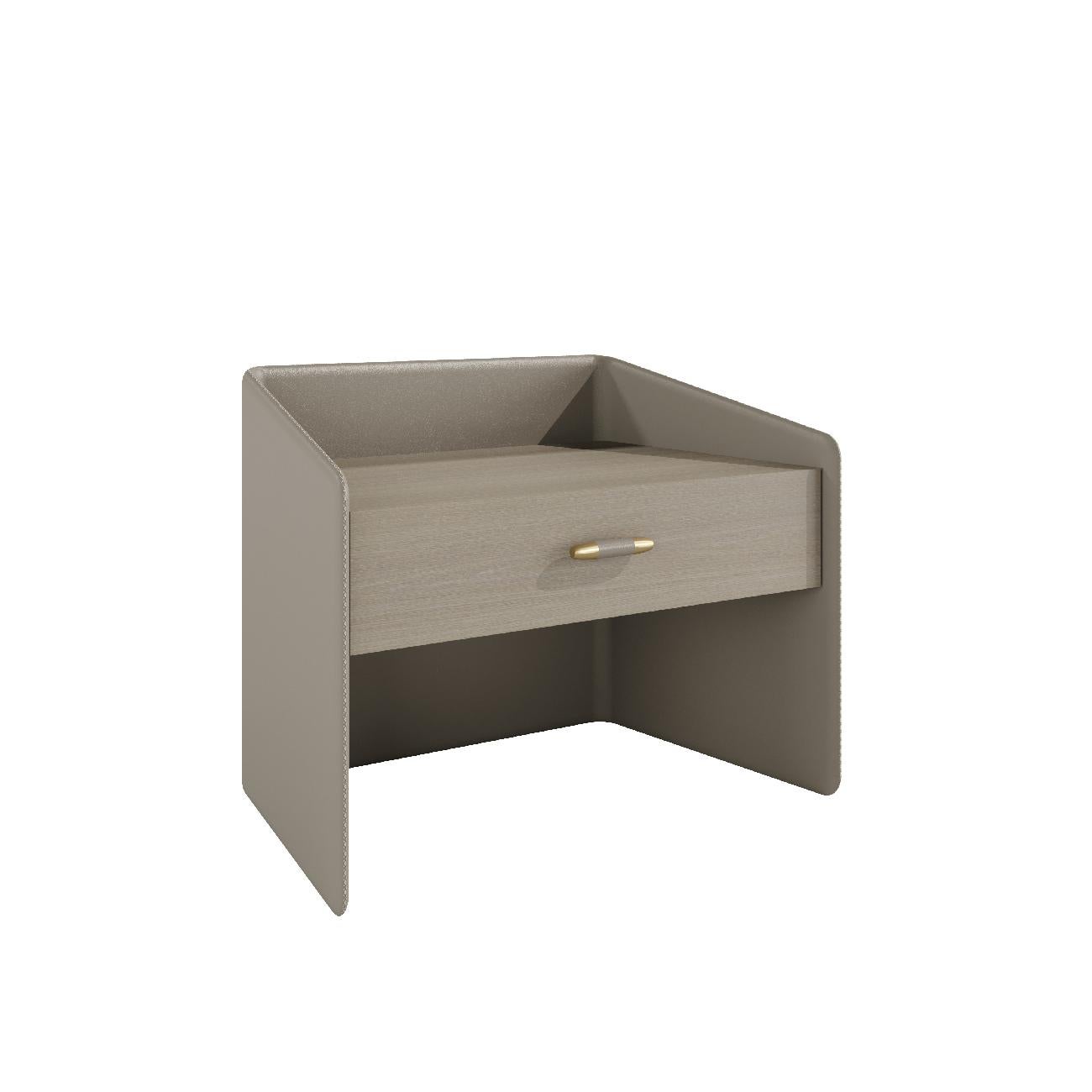 Pristine is a precious object covered in leather with a stitching details. 

The drawer is available in wood veneer or lacquered and the antique brass handle with leather makes this piece a unique object. The perfect balance of the elements makes