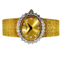Pristine Vintage Ladies Yellow Gold Oval Piaget Wrist Watch with Diamond Bezel