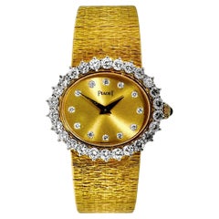 Pristine Vintage Ladies Yellow Gold Oval Piaget Wrist Watch with Diamond Bezel