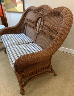 Pristine Wicker Loveseat with Blue and White Upholstered Cushions