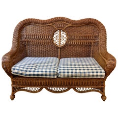 Pristine Wicker Loveseat with Blue and White Upholstered Cushions