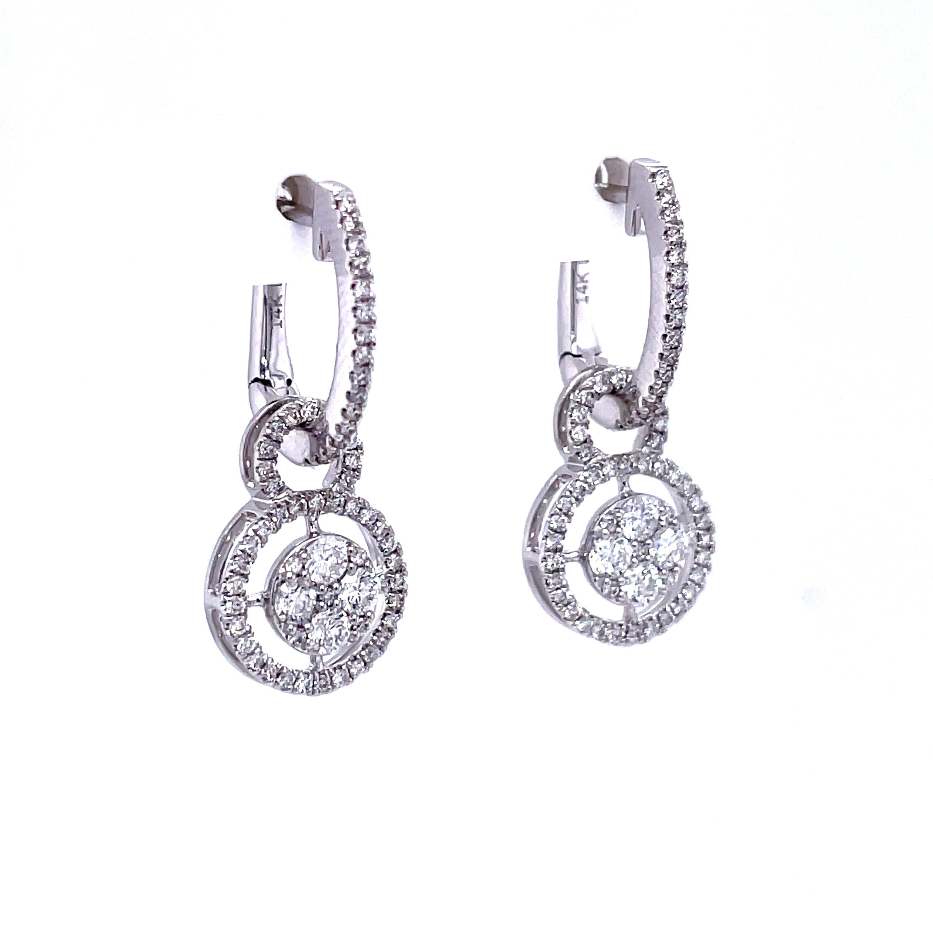 A stunning pair of IGI certified diamond earrings crafted in 14 karat white gold. These earrings feature 128 natural round brilliant diamonds weighing 0.72 cttw. (F-G color, I1 clarity). A hinge-back locking system keep the earrings secure. These