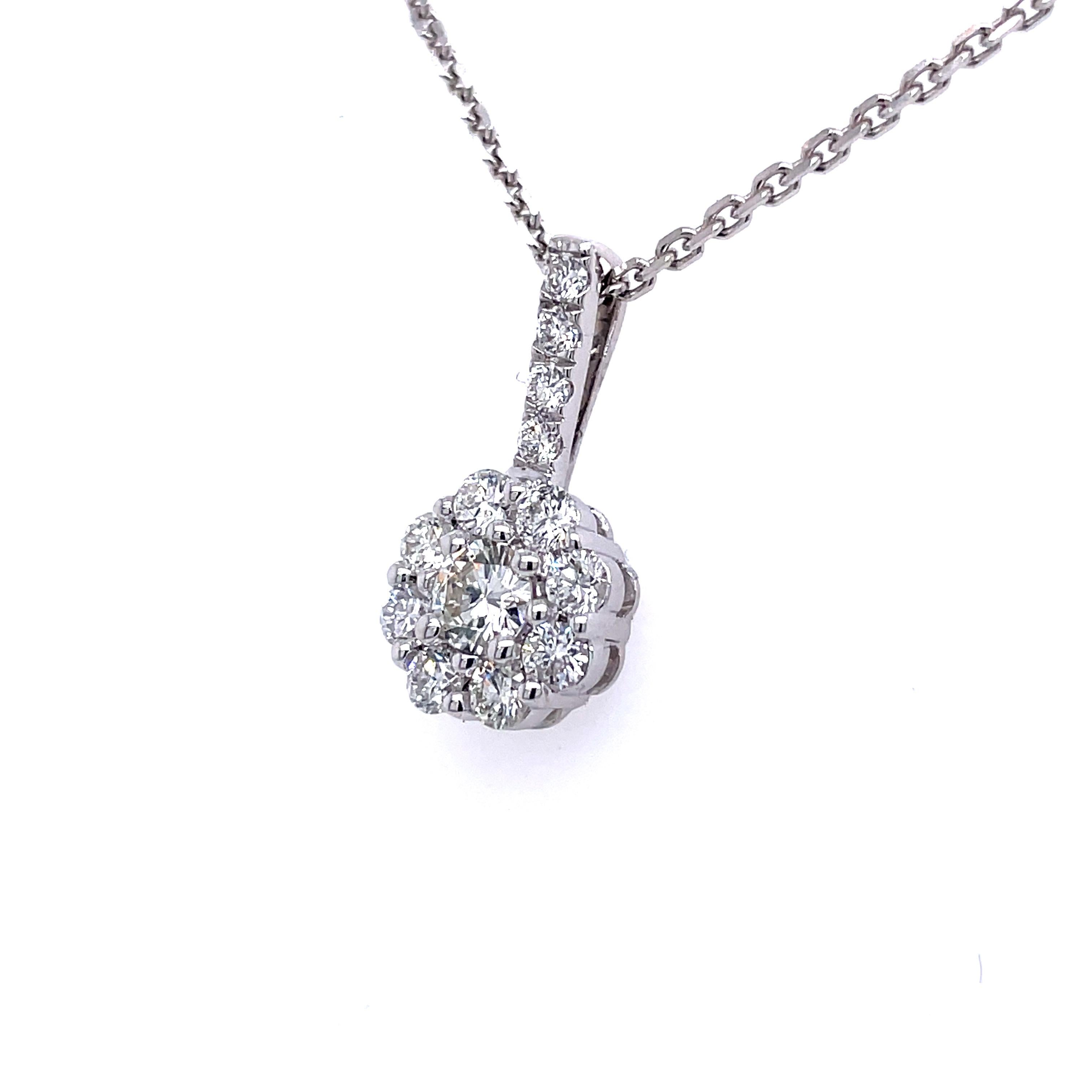 This stunning and elegant pendant showcases a beautiful, high quality 0.20 ct (H-I Color, VVS2-VS1 Clarity) round brilliant diamond in the center with an additional 12 diamonds weighing 0.30 cttw (H-I Color, I1 Clarity) accenting the bale and halo.