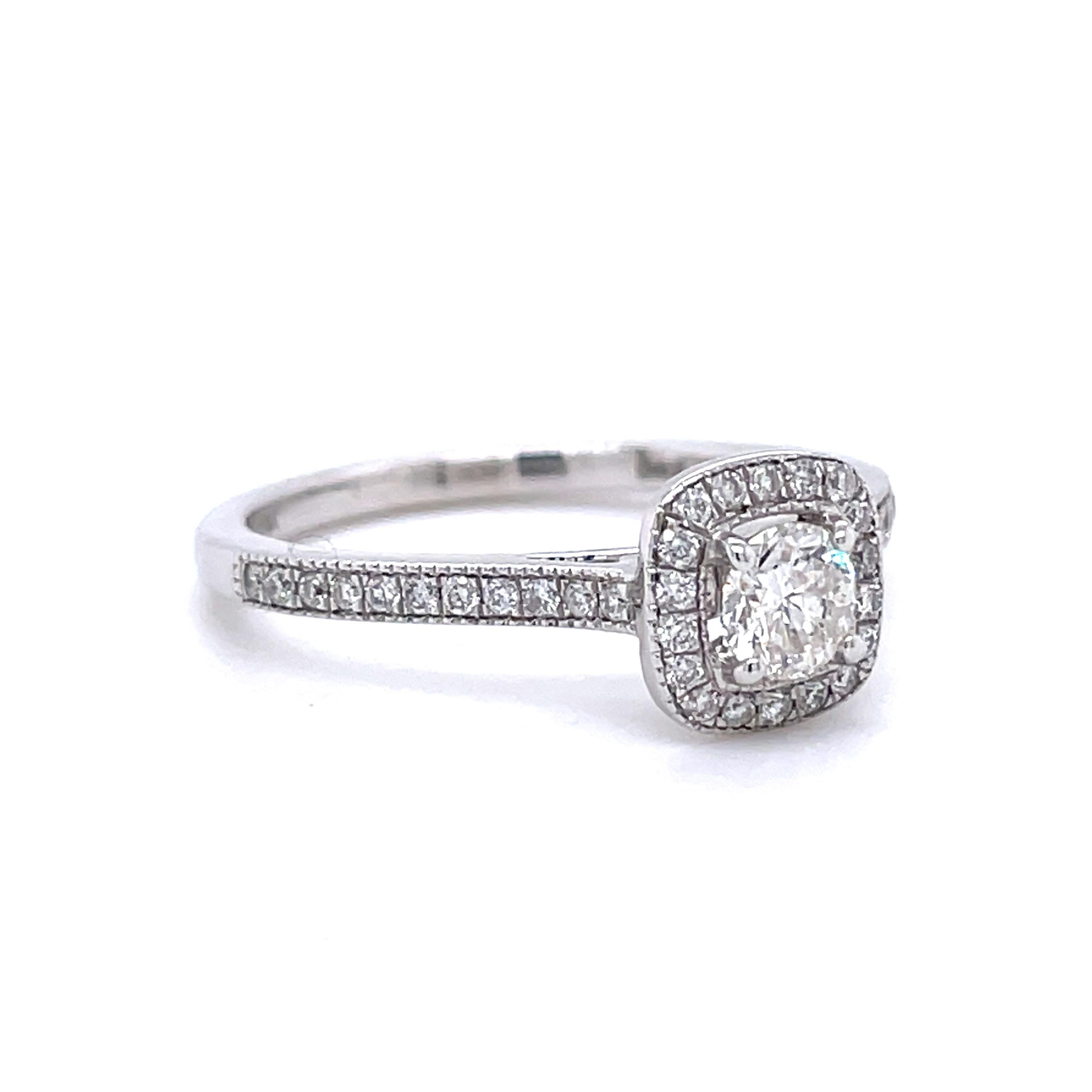 This stunning and elegant diamond ring has a beautiful 0.30 ct (H-I Color, I2 Clarity) round brilliant diamond in the center with an additional 40 diamonds weighing 0.21 cttw (H-I Color, I1 Clarity) accenting the sides and halo. The ring is crafted