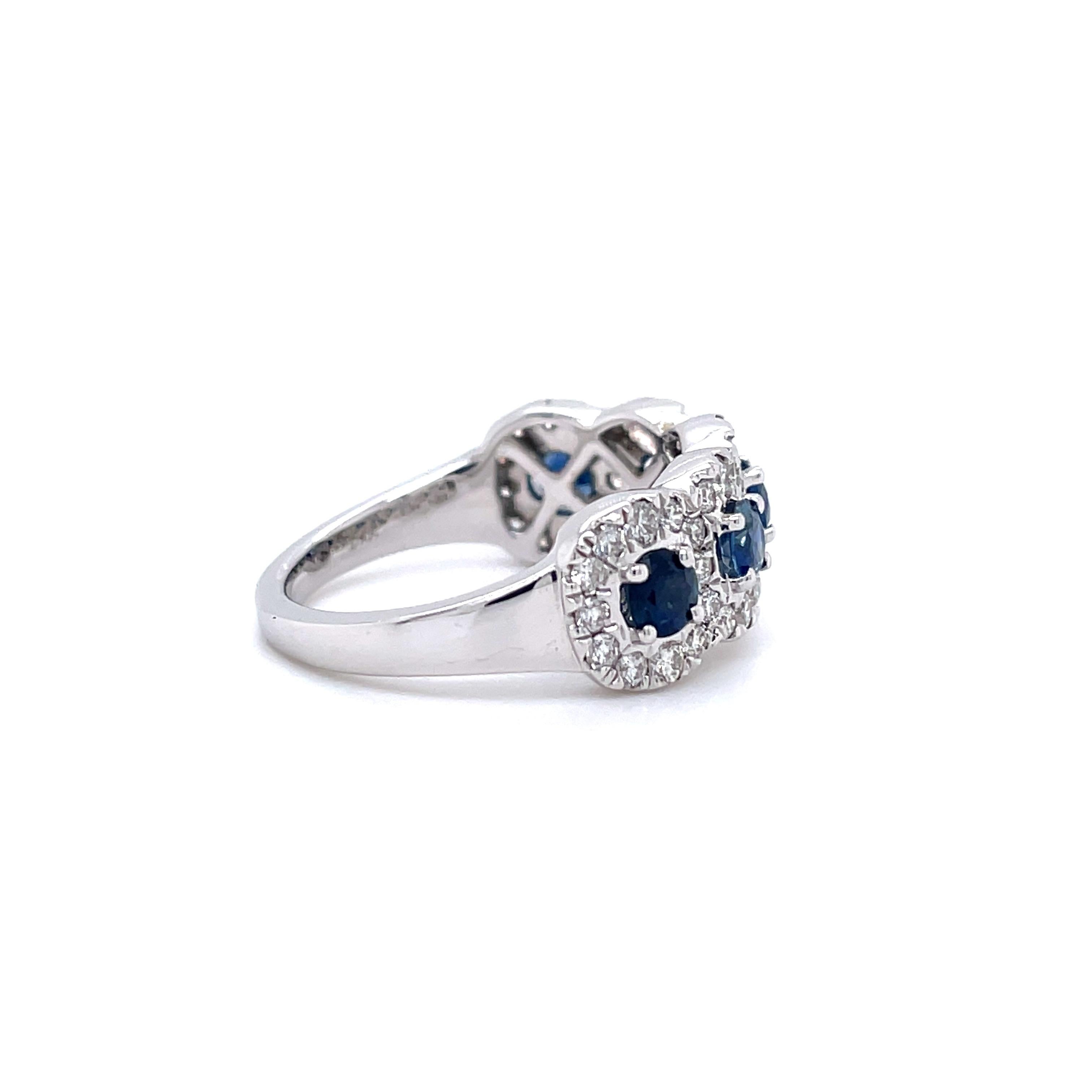 A stunning cocktail ring crafted in 14 karat white gold with 5 round natural blue sapphire stones, weighing 1.00 cttw. The measurements for these stones are 3.20 x 3.40 mm. This ring also contains 48 natural round brilliant diamonds weighing 0.67