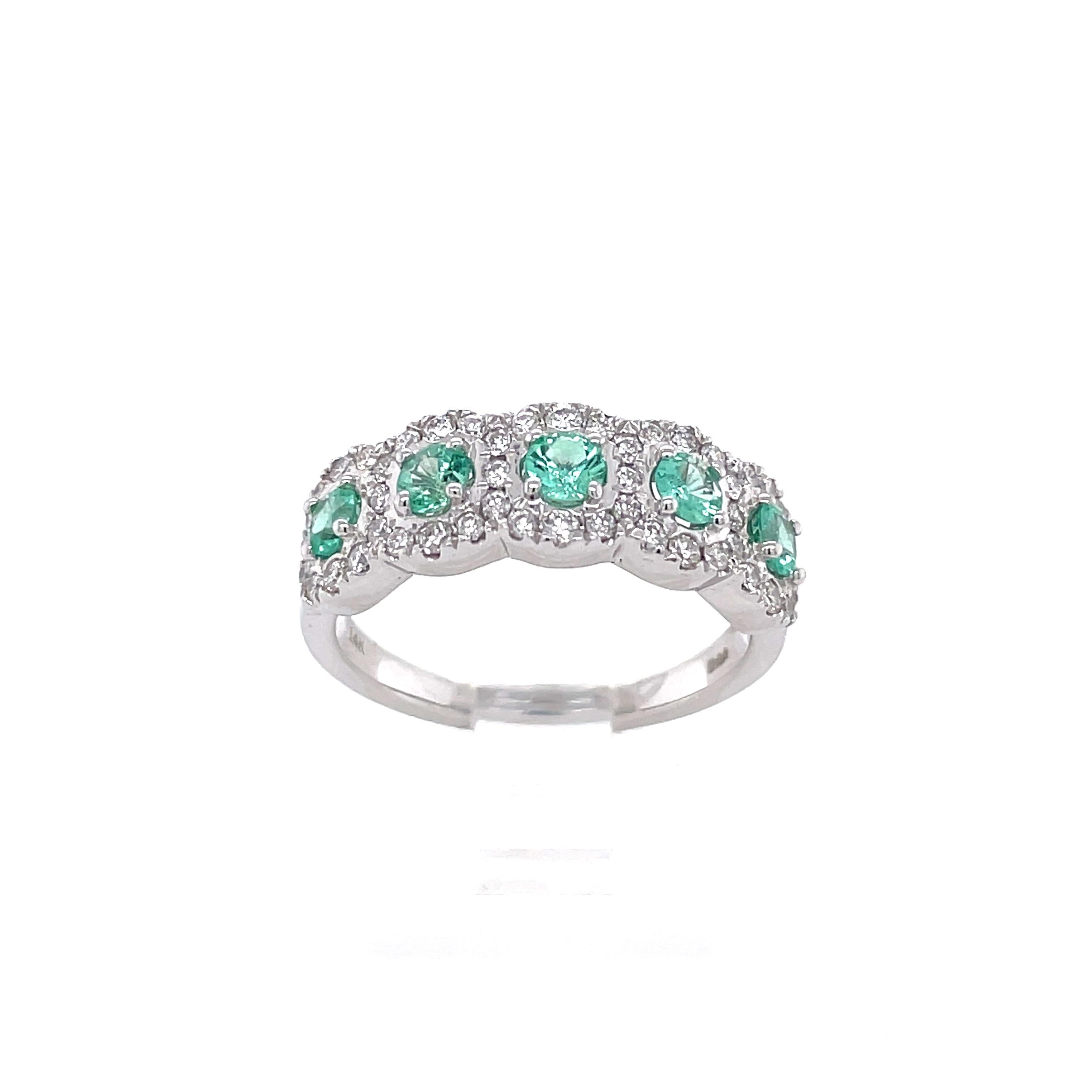 A stunning cocktail ring crafted in 14 karat white gold with 5 round natural translucent emeralds weighing 0.50 cttw. The measurements for these stones are approx 3 x 3 x 2 mm. This ring also contains 48 natural round brilliant diamonds weighing