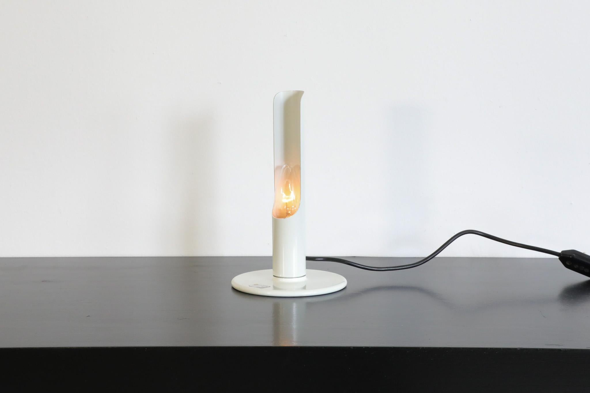 Incredible 'Prix' desk lamp by highly influential and highly innovative German designer Ingo Maurer for M Design, 1970's. This is a white enameled metal table lamp with round metal base and candelabra socket. This attractive lamp stylistically
