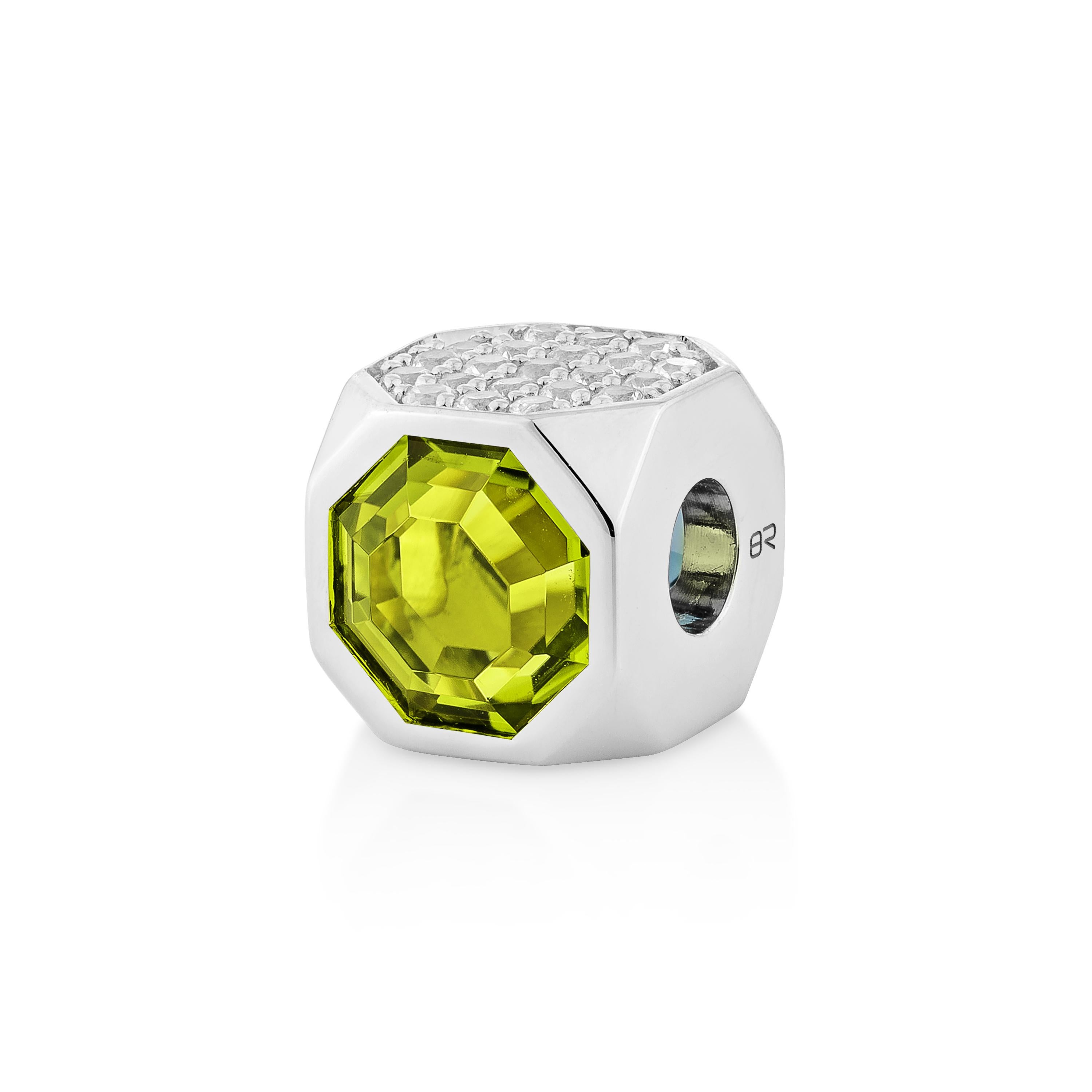 A captivating combination of vivid peridot and serene blue topaz is elegantly highlighted by a sparkling sapphire accent. Set in 18K white gold, this pendant exudes timeless charm and vibrant sophistication.

Peridot: 1.82 carat, 8X8mm size, octagon