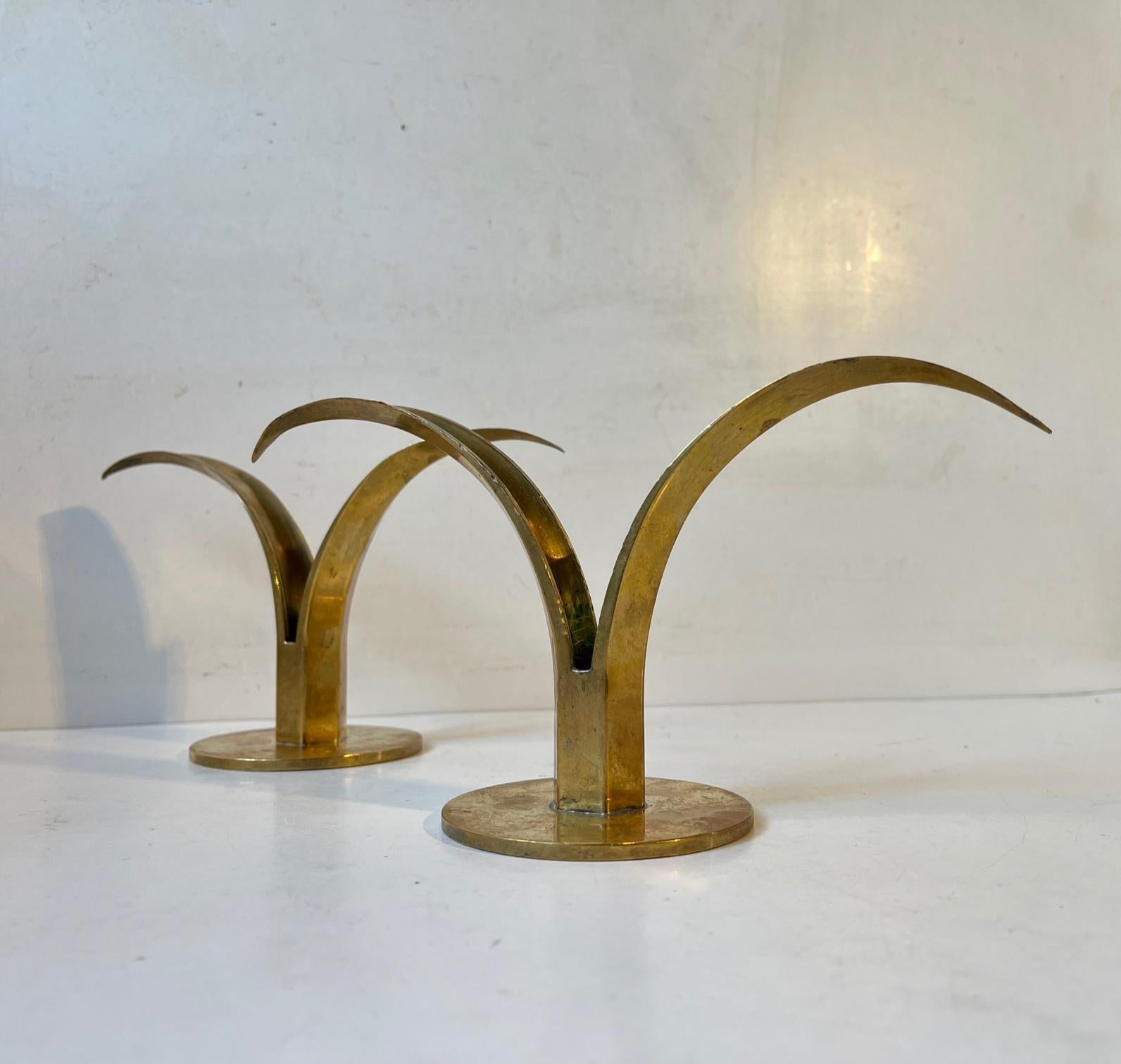 A pair of early 1950s brass candleholders designed by Ivar Ålenius Björk. The model is called the Liljan or 