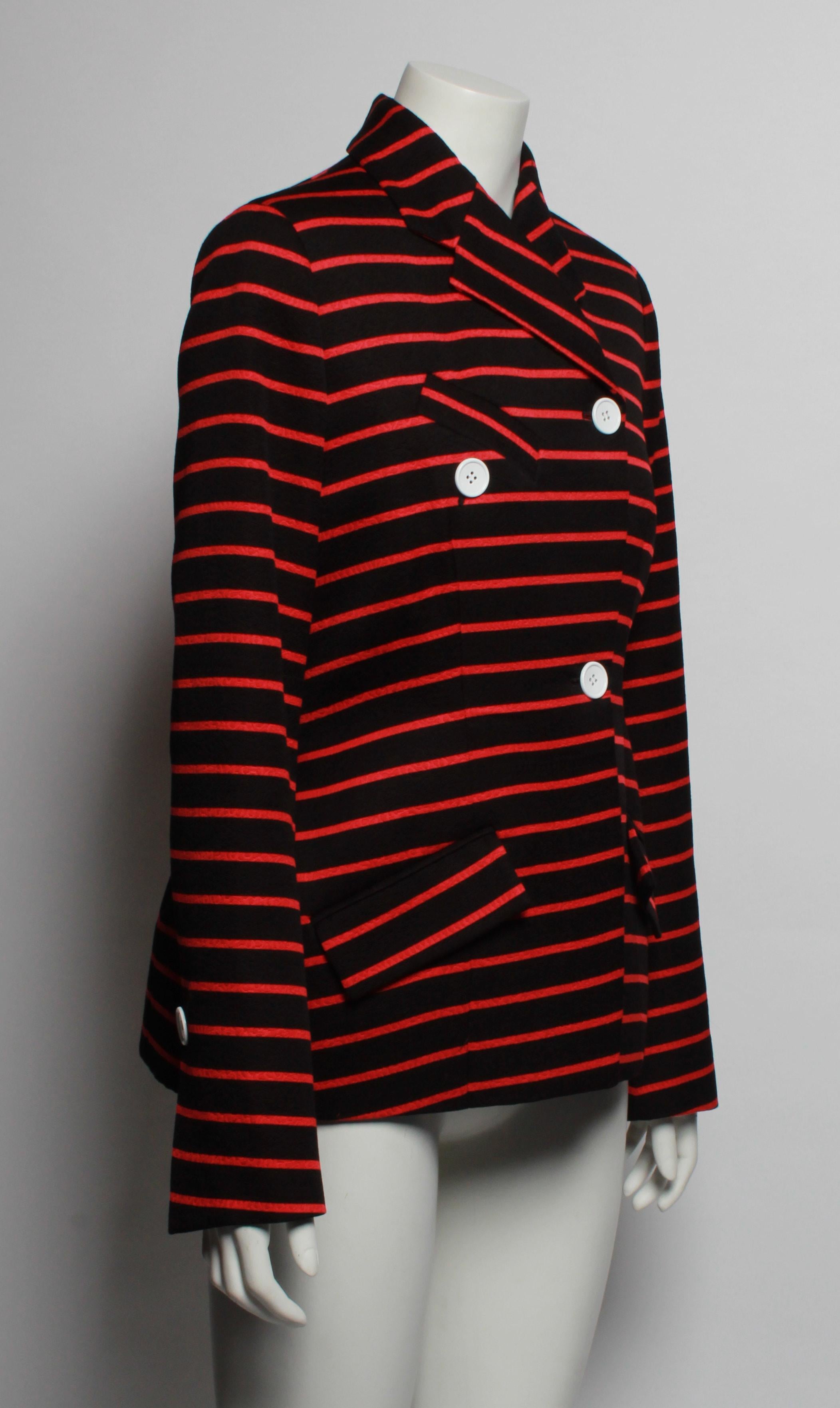  This Proenza Schouler double breasted striped jacket is made of cotton and wool blend jacquard. and features a striking red stripe on a black base.

Add a touch of sophisticated charm to your wardrobe with this  wrap front striped jacket that