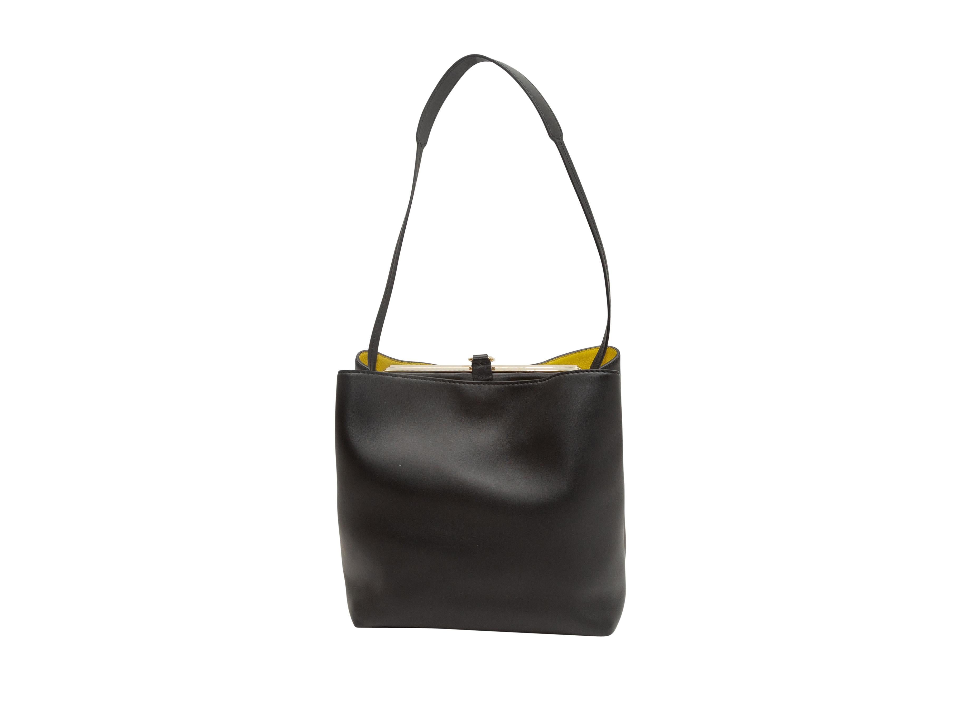 Product details: Black leather shoulder bag by Proenza Schouler. Gold-tone hardware. Yellow leather interior. 11.5