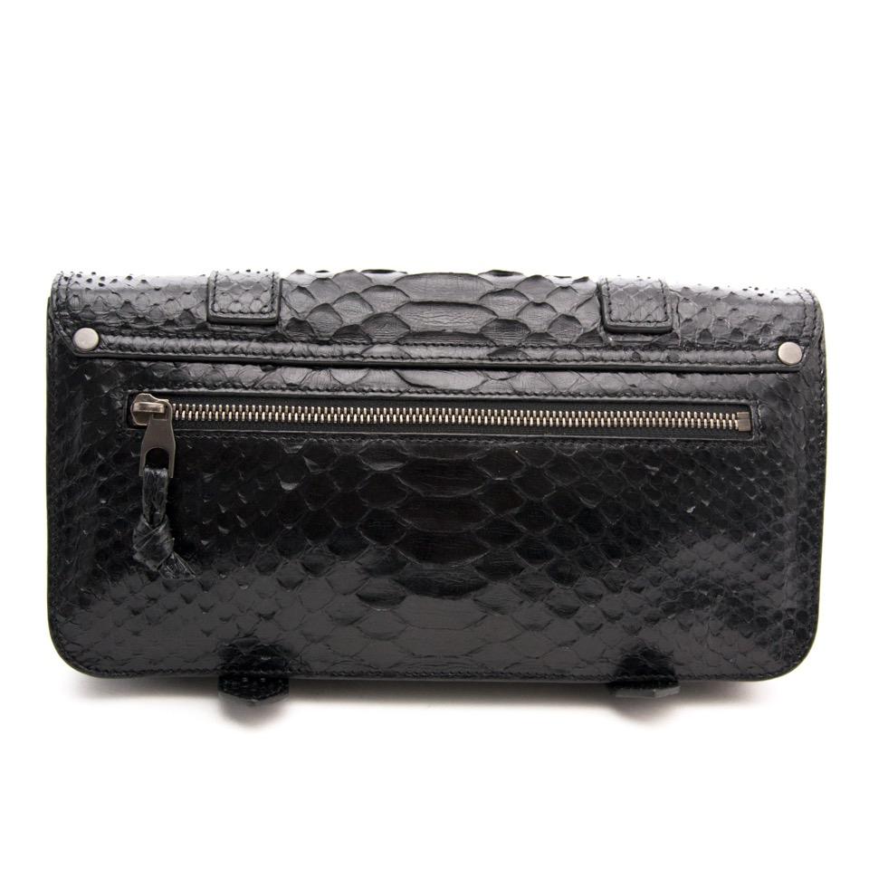 Proenza Schouler Black Python Clutch
Python flap front clutch with metal tab closure.
Very elegant and easy to wear. Perfect evening bag.
Two compartment interior with zipper side pocket and extra exterior zipper compartment.