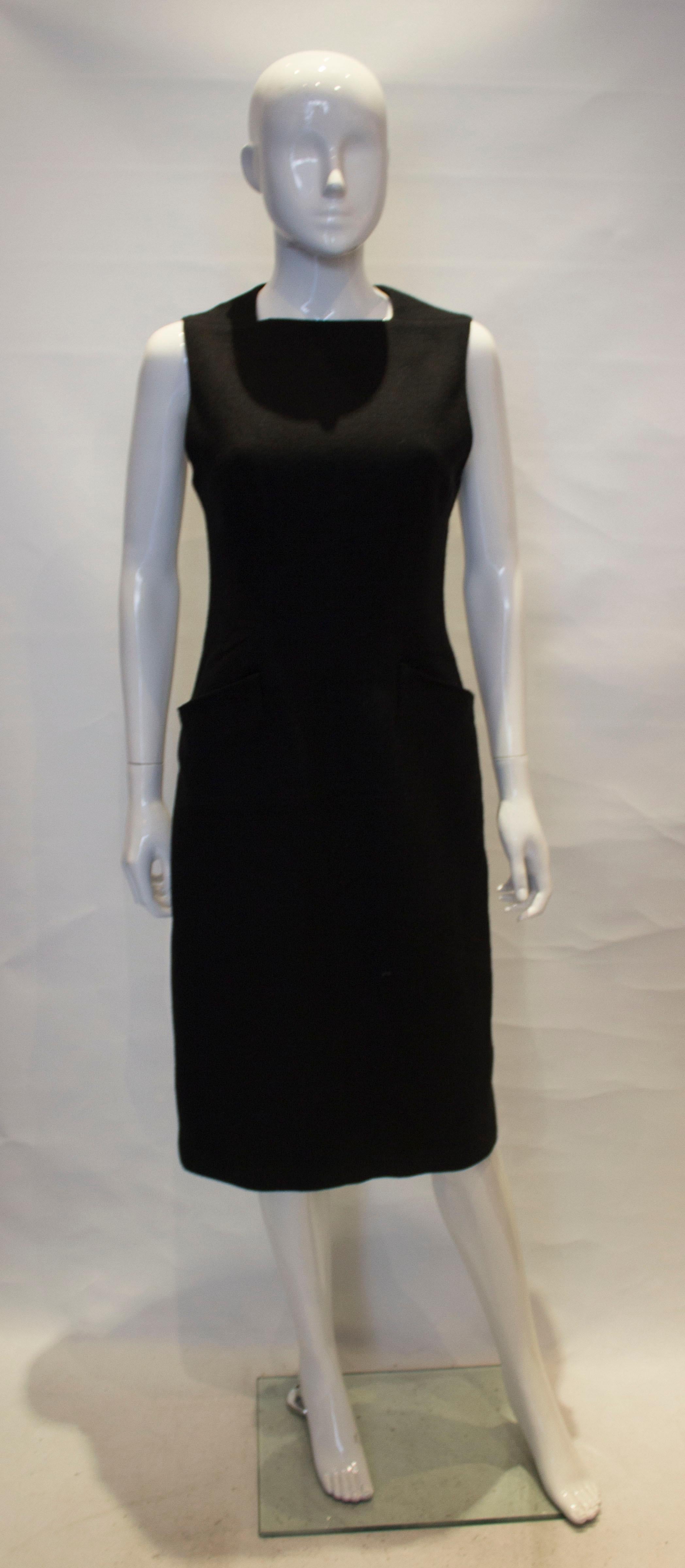 A chic shift dress by Proenza Schouer, The dress has a a square neckline, pockets at hip leval, a 6 1/2 '' slit at the back and a central back zip. Labelled US size 4.