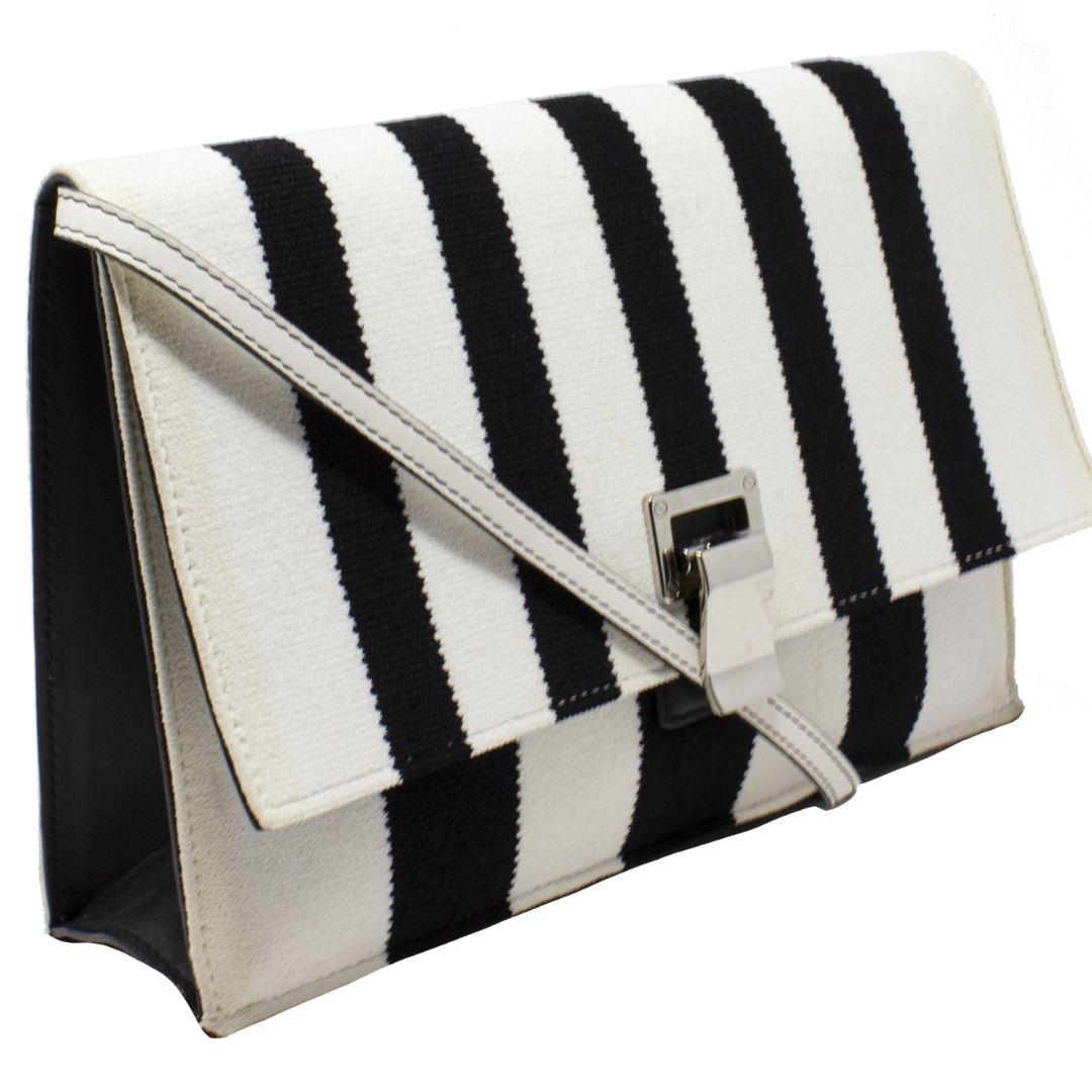 Add a little bit of edge to any outfit but still keep it casual with this Proenza Schouler piece! Rendered in black and white stripes with beige trimmings this crossbody bag has silver-tone hardware with a single flat shoulder strap. The flip-lock