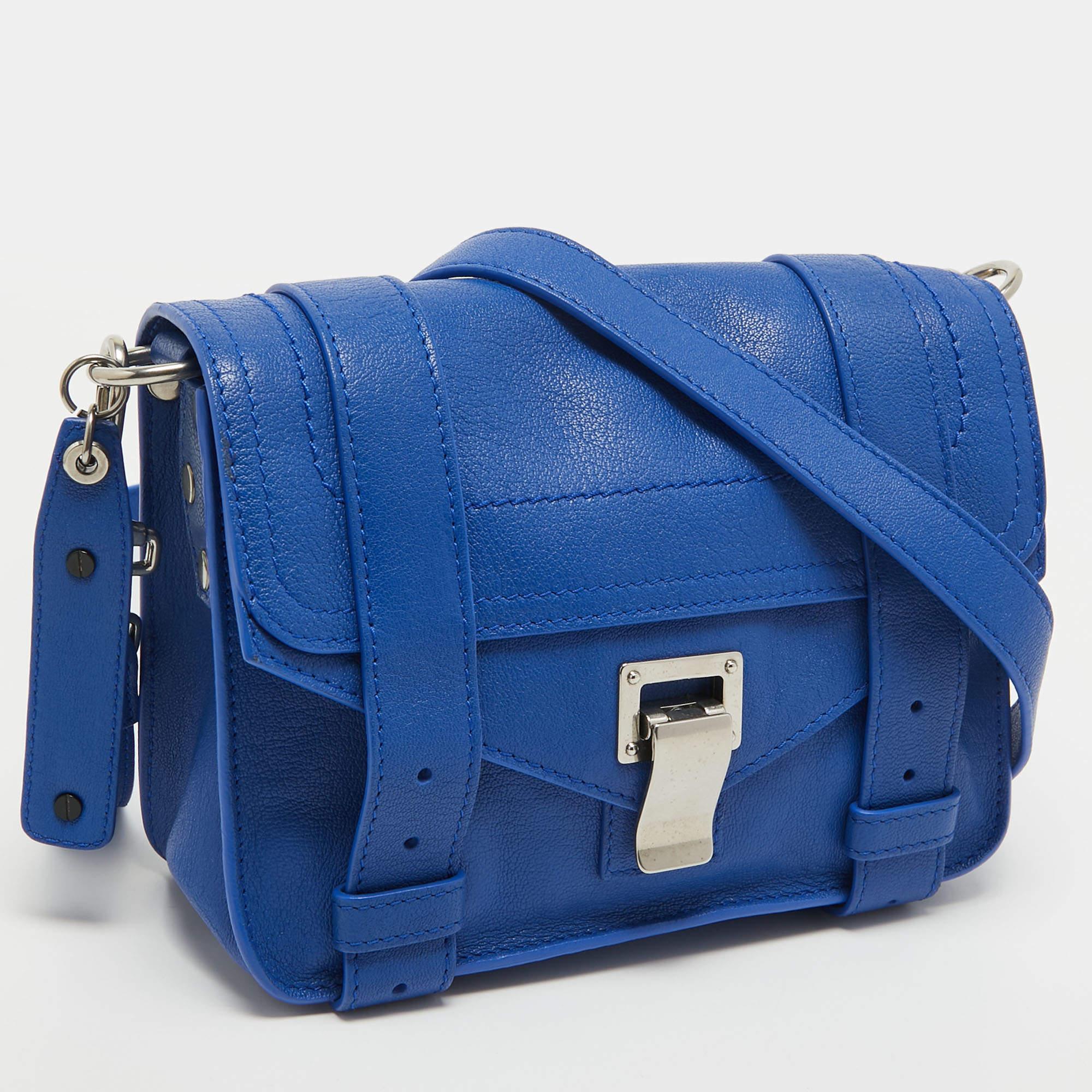 The Proenza Schouler PS1 Crossbody Bag is a chic and compact accessory, featuring premium leather in a vibrant blue hue. The iconic PS1 design includes a front flap with signature flip-lock closure, a detachable crossbody strap, and a well-organized