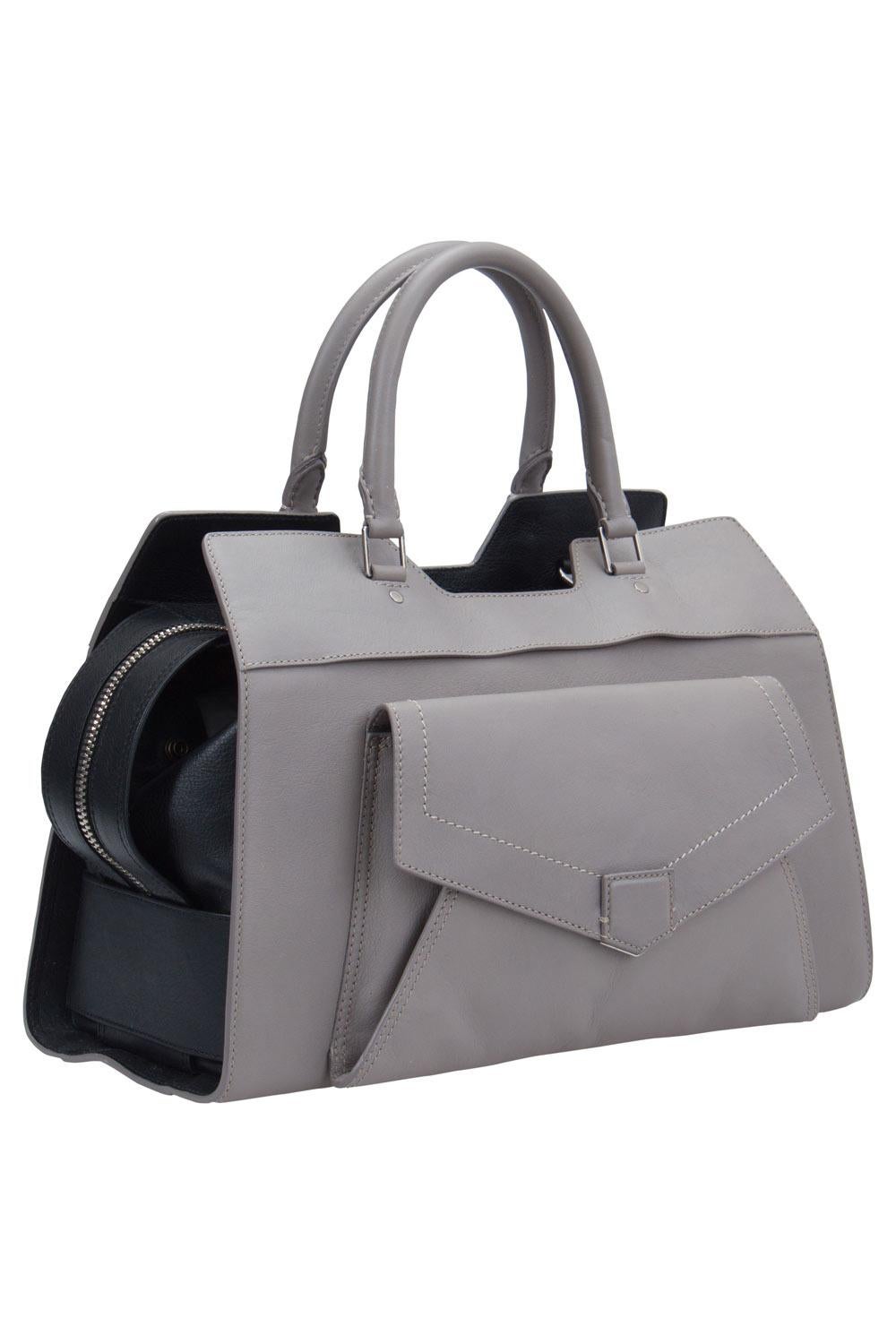 This PS13 satchel by Proenza Schouler has a sophisticated look. Crafted from leather, it is held by two top handles and a detachable shoulder strap. The top zipper opens to a spacious fabric interior and the bag is complete with a front flap pocket.