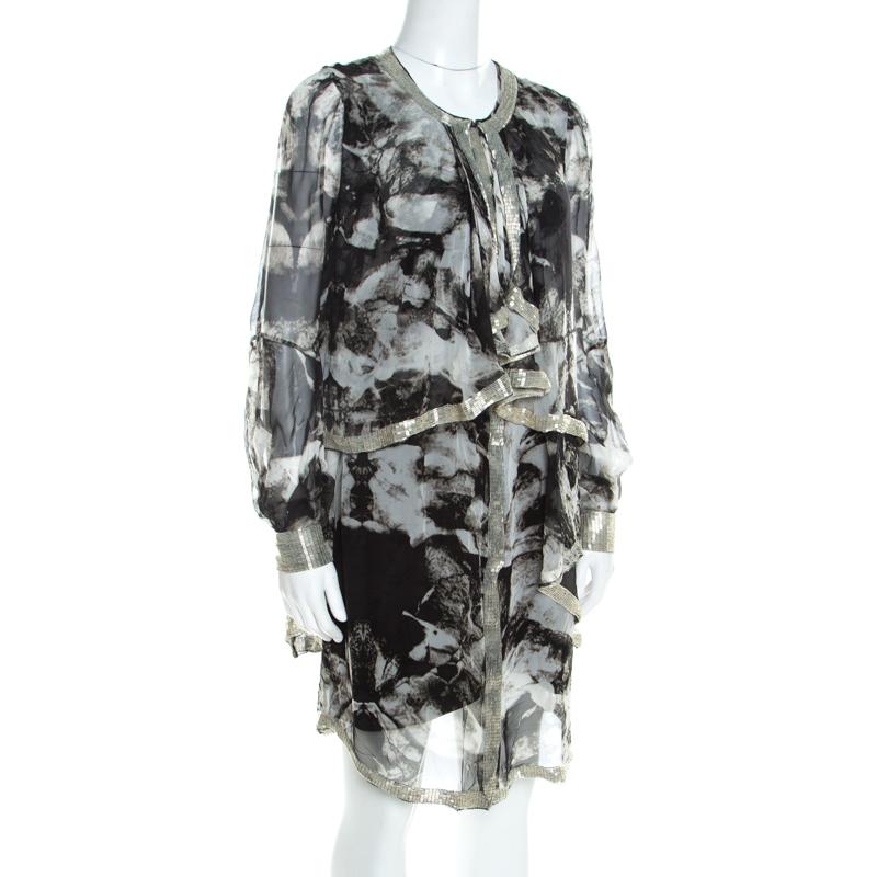 This Proenza Schouler set of a dress and jacket is comfortable and visually appealing. The dress is sleeveless and it is designed with abstract prints and embellished trim. The jacket has matching prints and trims but in a waterfall-like