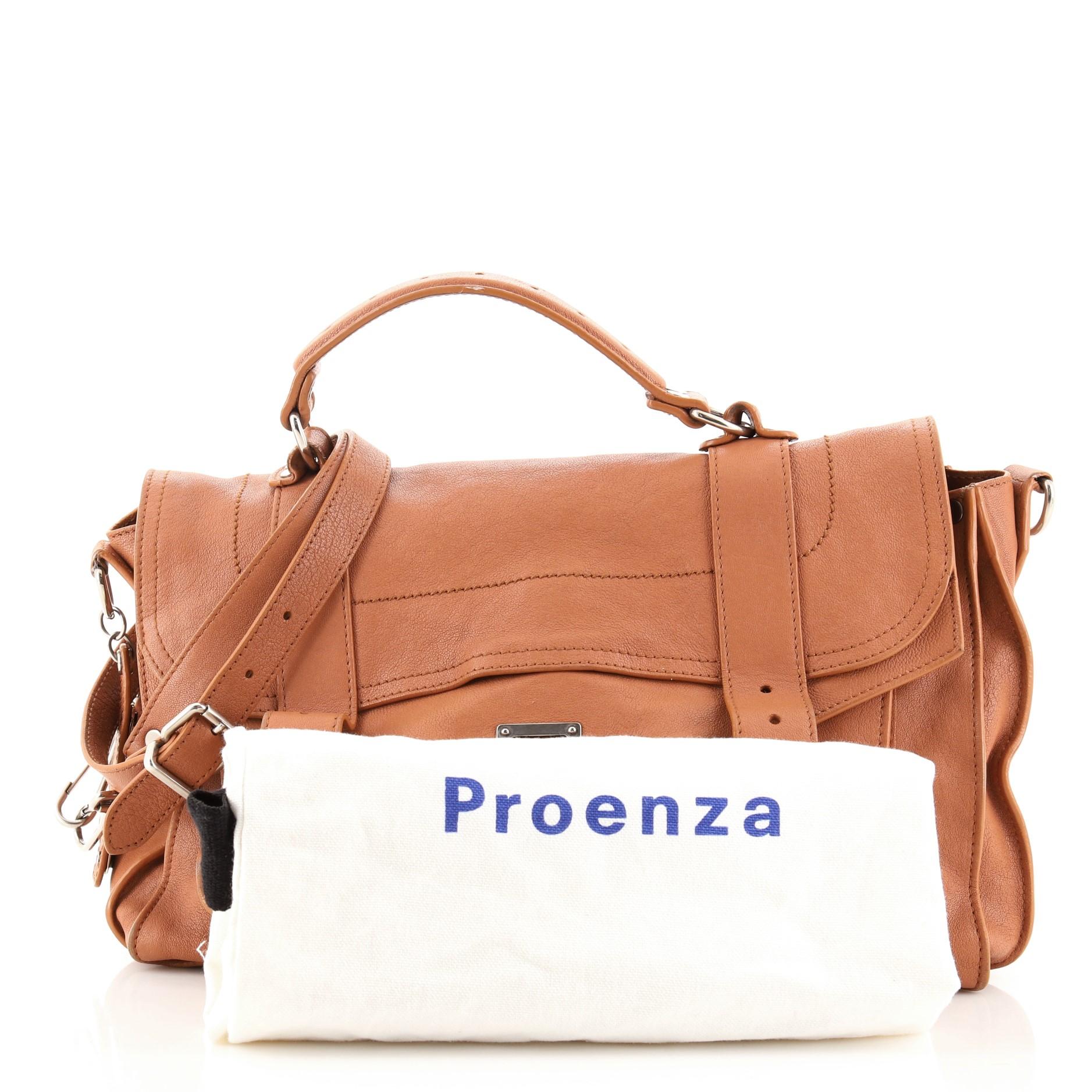 Condition: Good. Odor in interior. Creasing on exterior, moderate wear and darkening on exterior corners, handles and rear zipper pull, heavy splitting on strap and handle base wax edges. Cracking on exterior and side opening wax edges, darkening on