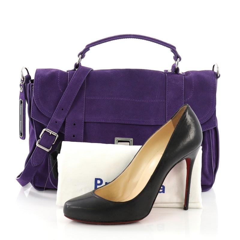 This Proenza Schouler PS1 Satchel Suede Medium, crafted in purple suede, features a leather top handle, exterior back zip pocket, and aged silver-tone hardware. Its flip-clasp closure opens to a gray fabric interior with a zip pocket. **Note: Shoe