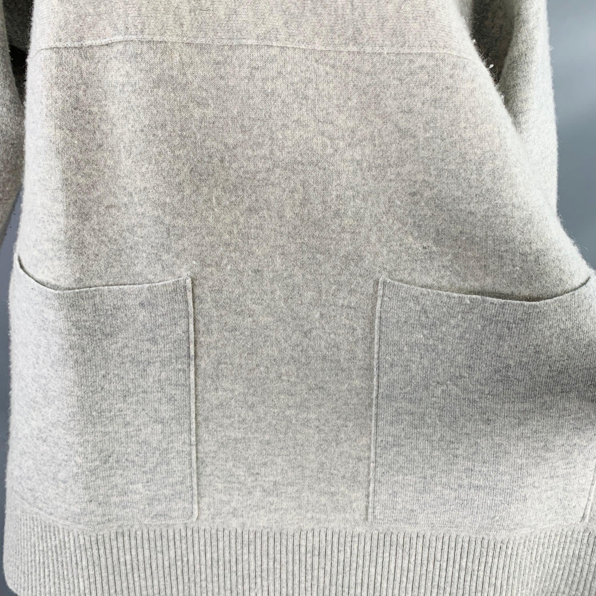 PROENZA SCHOULER pullover
in a heather grey cashmere blend knit featuring long sleeves, two large patch pockets, and crew neck.Good Pre-Owned Condition. Moderate pilling, minor mark at neck. 

Marked:   XS 

Measurements: 
 
Shoulder: 16.5 inches