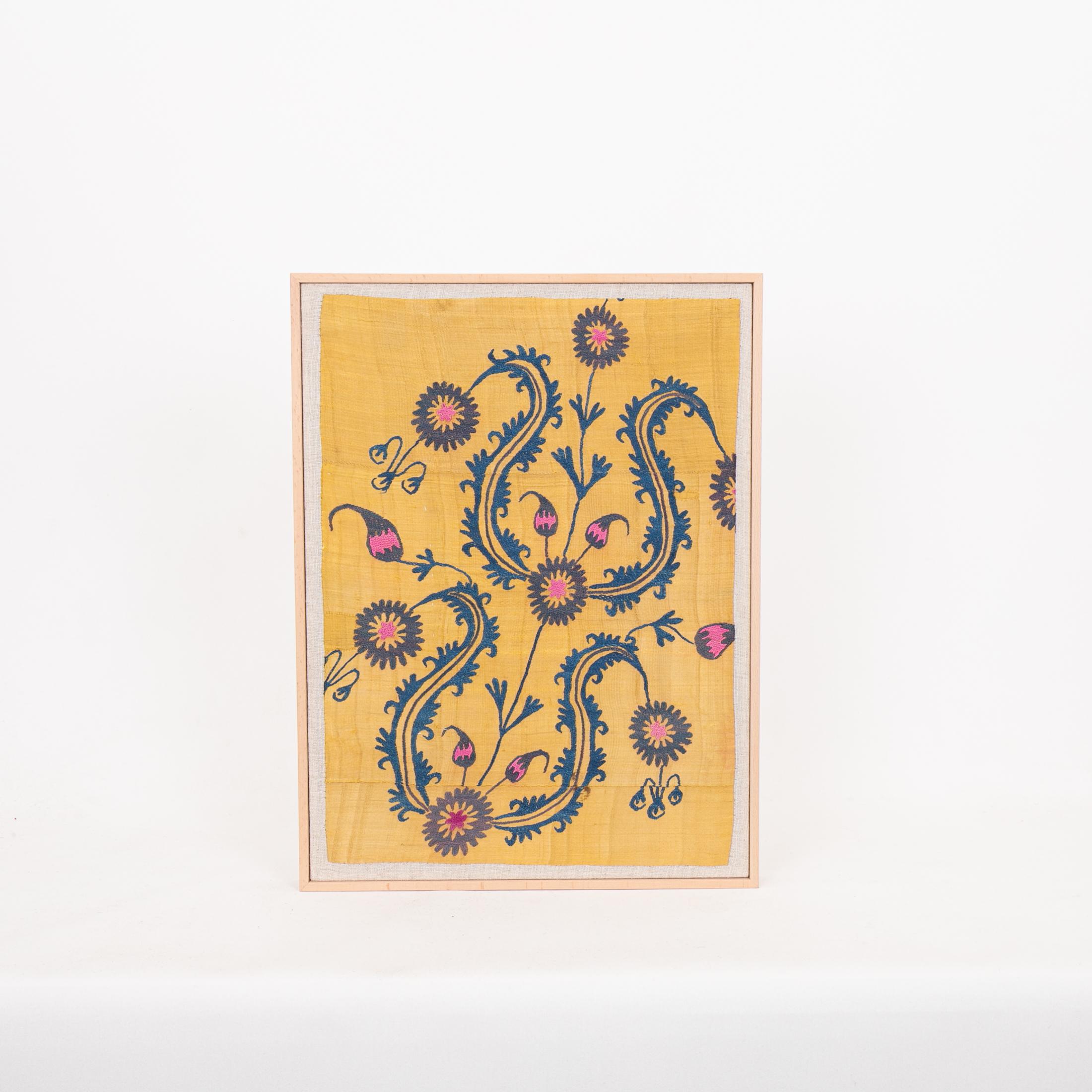 The suzani fragment on the frame is from a 19th C. Suzani. It is hand backed on linen and streched over a strecher and finished with a wooden frame.
Ready to go on any wall.

The item is made from an antique used suzani , therefore it is not in