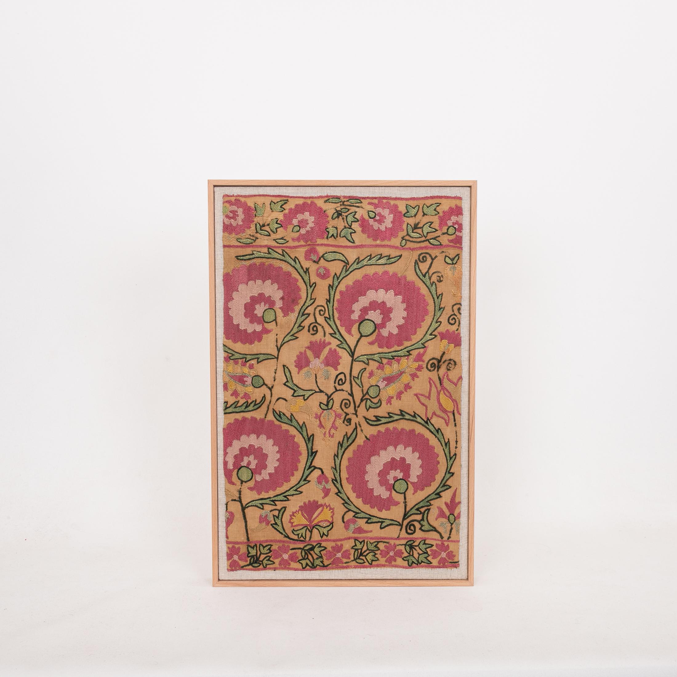 Professionally Framed Antique Suzani Fragment, 19th Century.

The suzani fragment on the frame is from a 19th C. Suzani. It is hand backed on linen and streched over a strecher and finished with a wooden frame.
Ready to go on any wall.

The item is