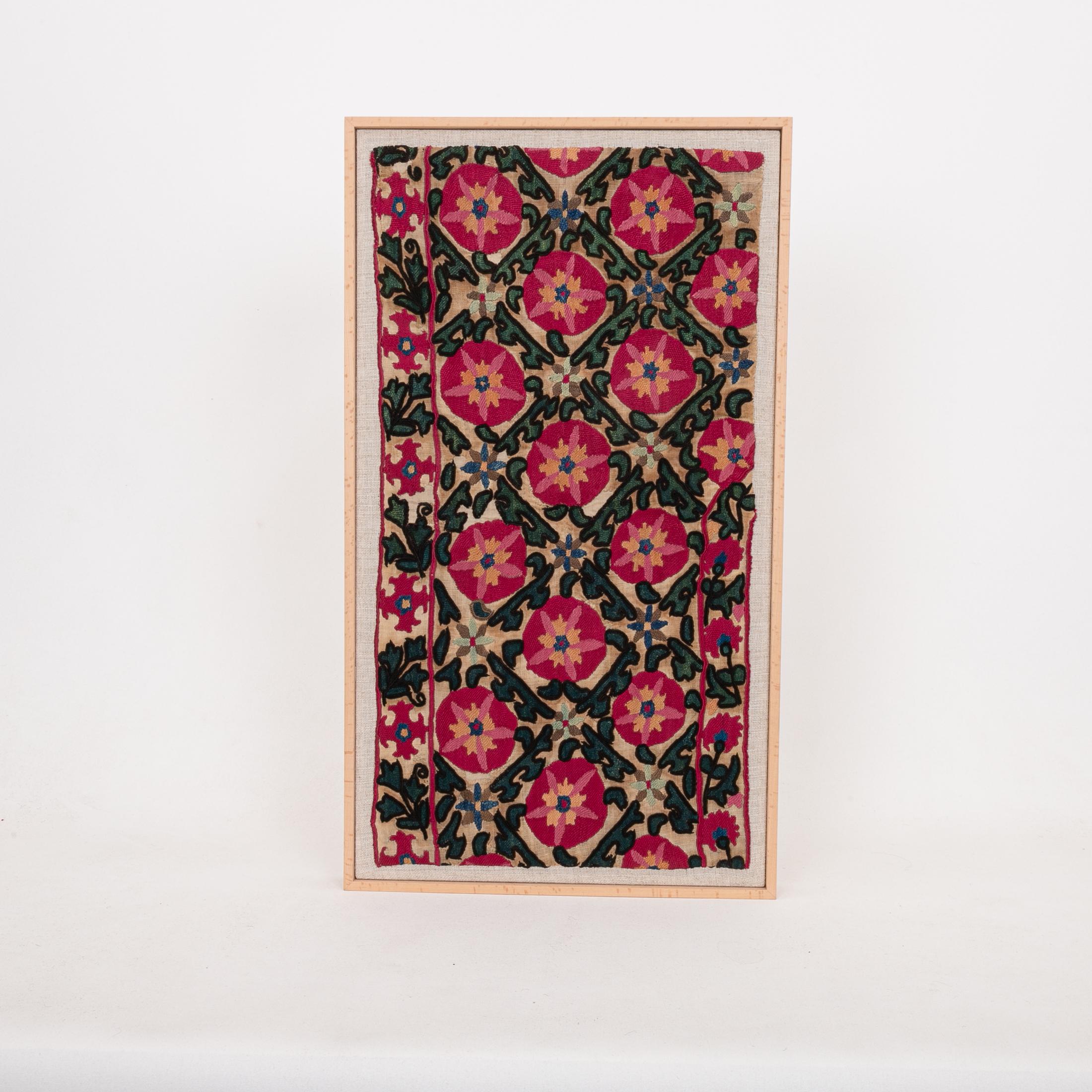 The suzani fragment on the frame is from a 19th C. Suzani. It is hand backed on linen and streched over a strecher and finished with a wooden frame.
Ready to go on any wall.

The item is made from an antique used suzani , therefore it is not in