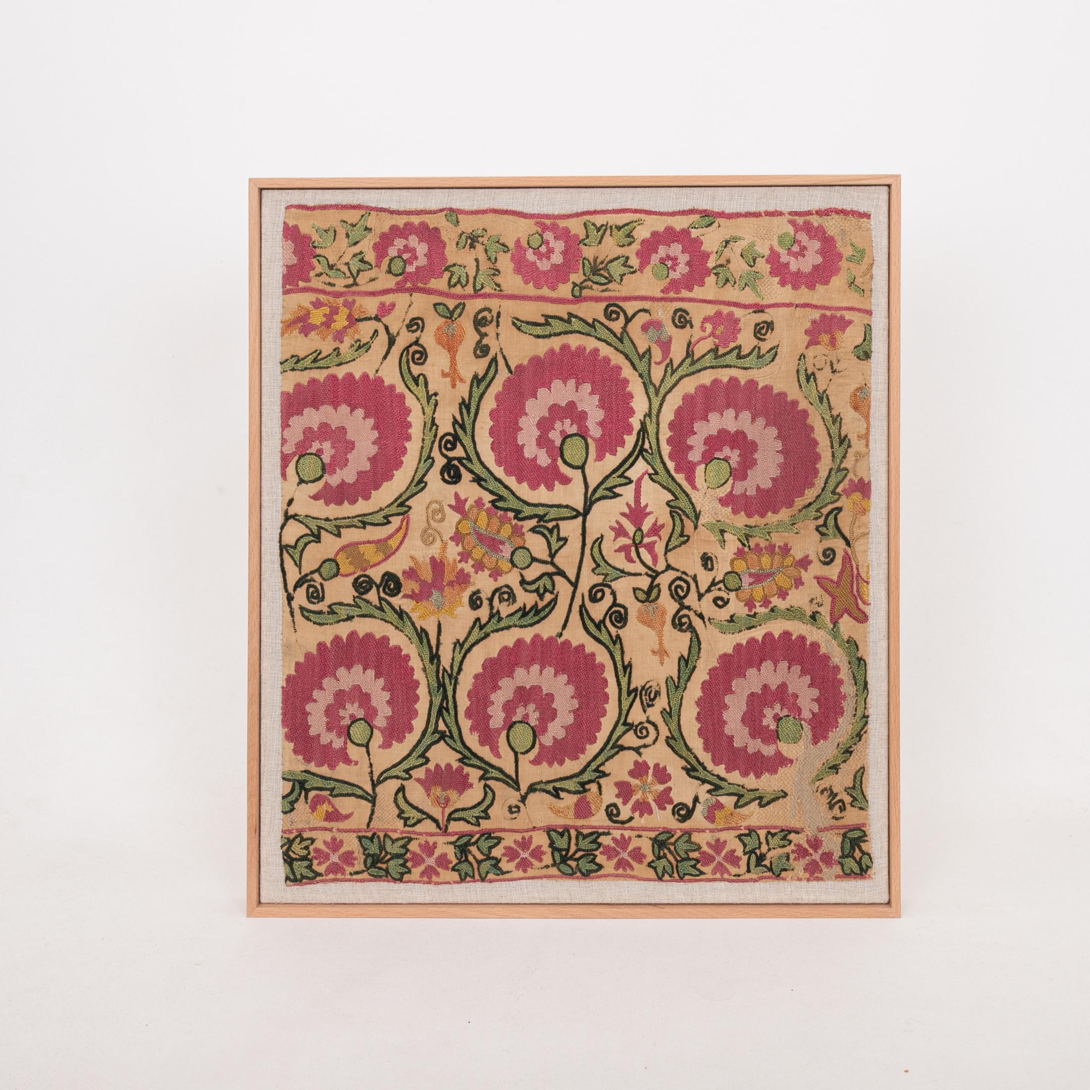 The suzani fragment on the frame is from a 19th C. Suzani. It is hand backed on linen and streched over a strecher and finished with a wooden frame.
Ready to go on any wall.

The item is made from an antique used suzani , therefore it is not in