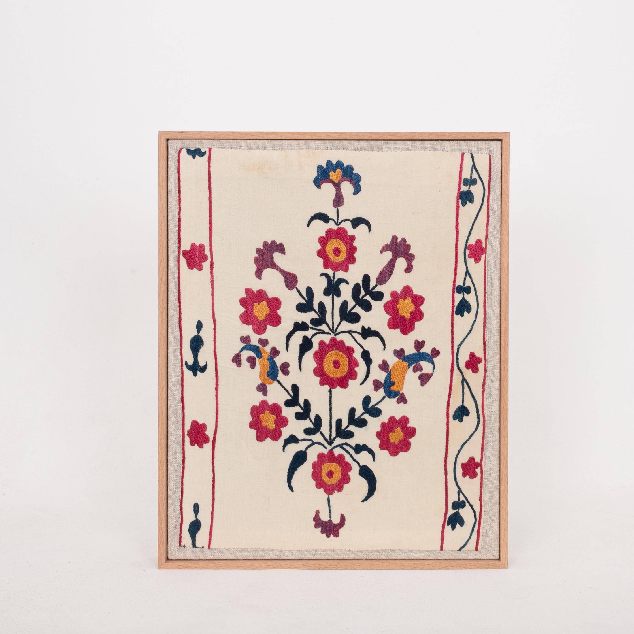 The suzani fragment on the frame is from a 19th C. Suzani. It is hand backed on linen and streched over a strecher and finished with a wooden frame.
Ready to go on any wall.

The item is made from an antique used suzani , therefore it is not in
