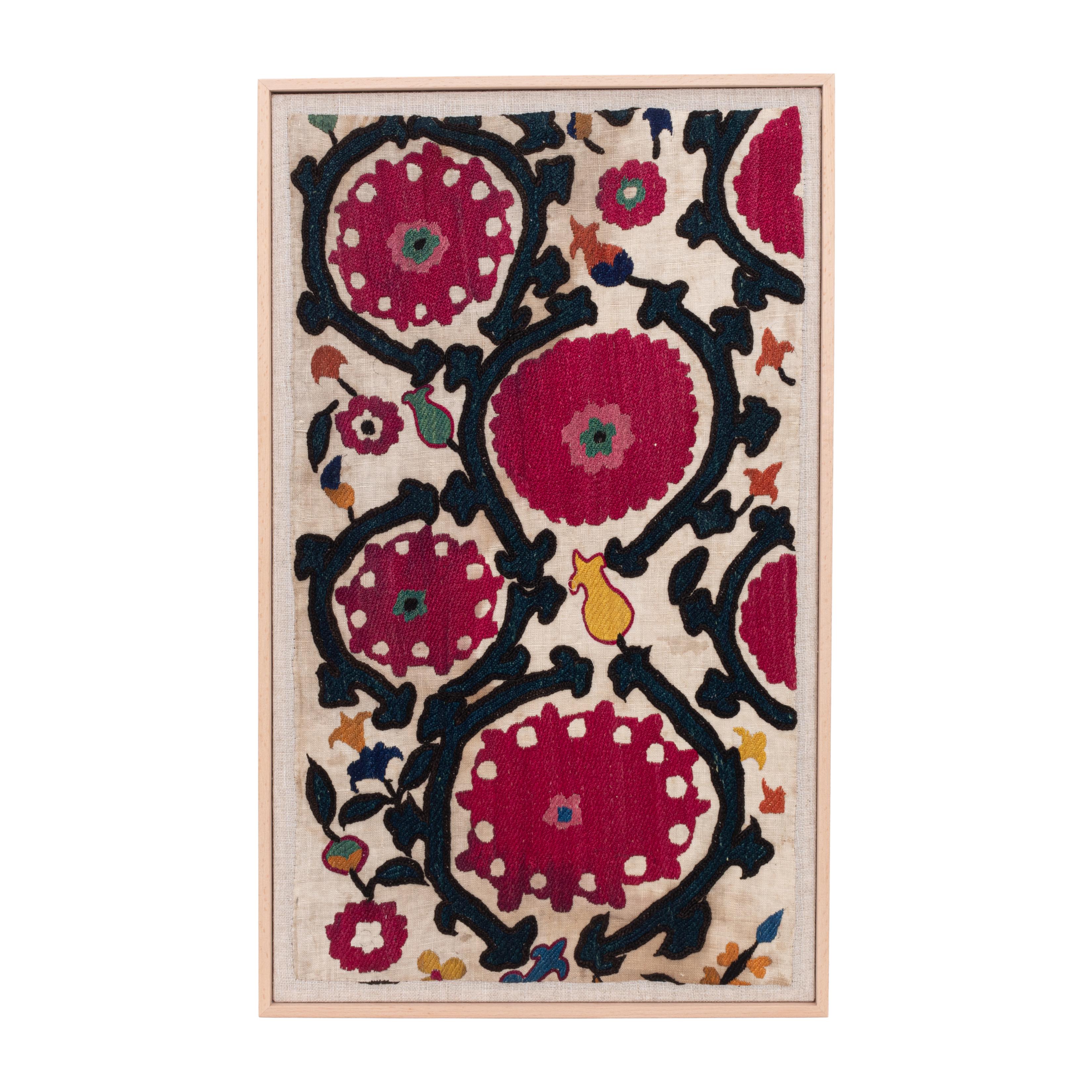 First the fragment has been hand backed on a linen fabric, then stretched over a wooden stretcher and finished with a wooden frame.
Late 19th C. Uzbekistan
Ready to go on any wall.

Framed Item above is made from a used and antique embroidery
