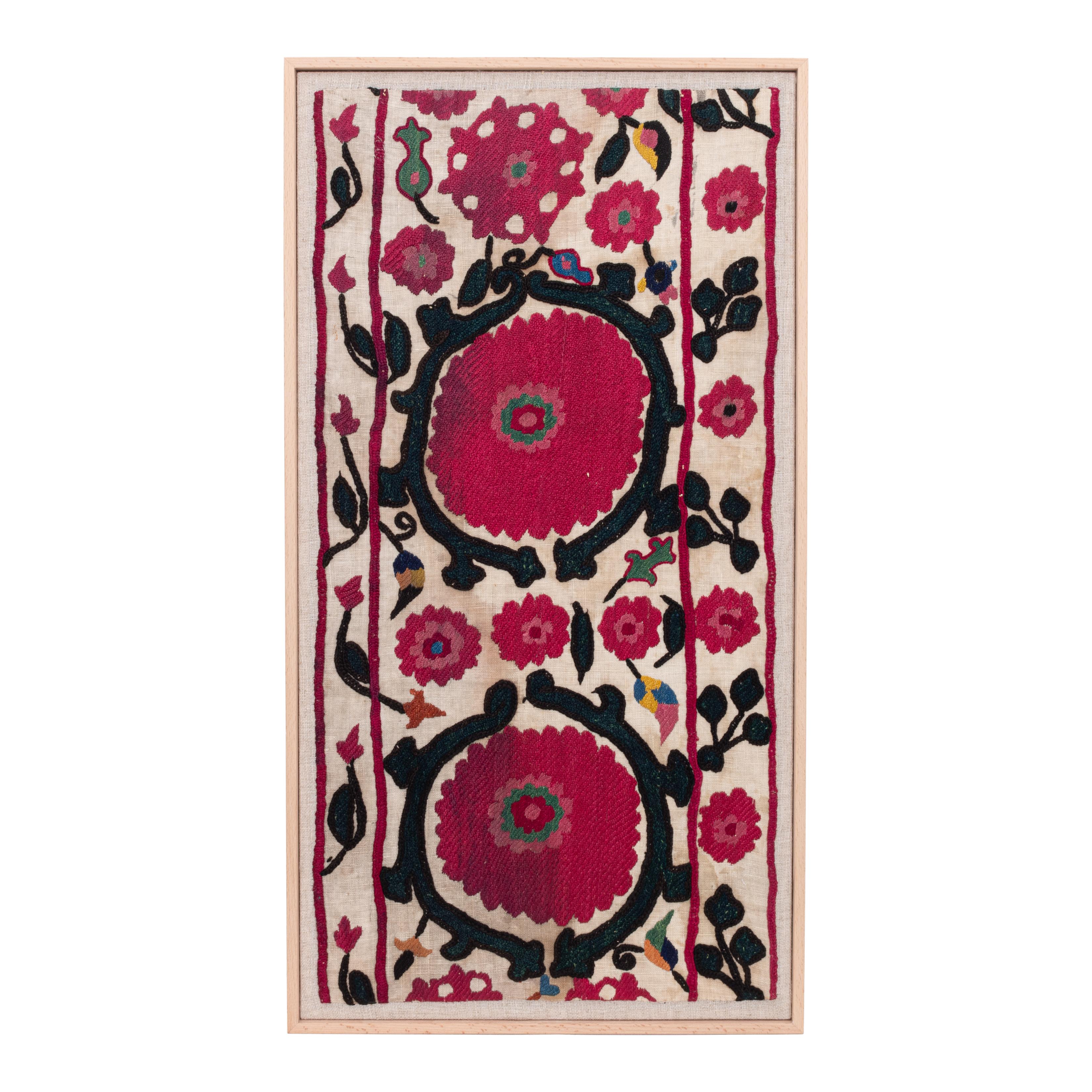 First the fragment has been hand backed on a linen fabric, then stretched over a wooden stretcher and finished with a wooden frame.
Late 19th C. Uzbekistan
Ready to go on any wall.

Framed Item above is made from a used and antique embroidery