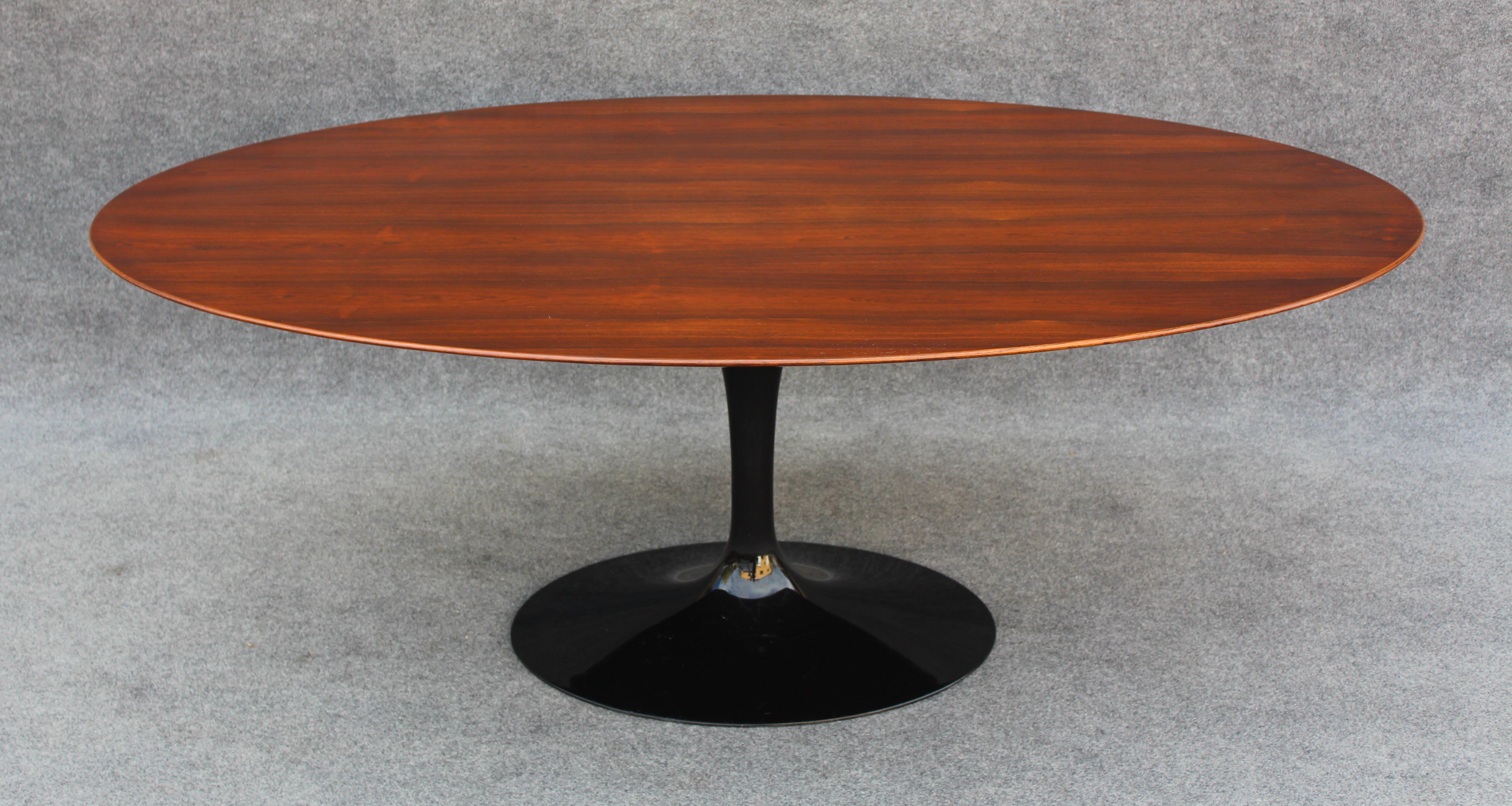 This rare and exquisite table was designed by legend Eero Saarinen for Knoll. Featuring a rare top, this oval top is made of Brazilian rosewood, which is beautifully figured and bookmatched. This is real rosewood, as Brazilian rosewood is now banned