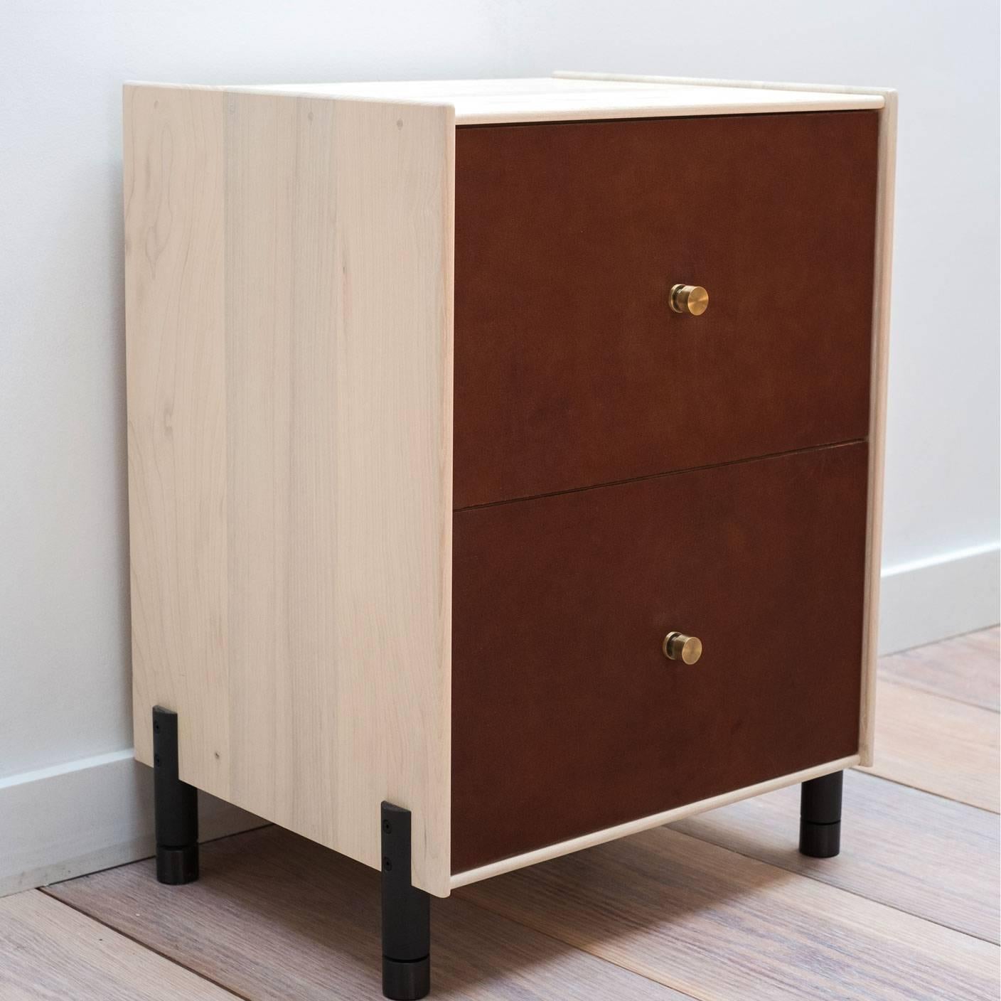The Profile Bedside Table is an elevated take on traditional cabinet construction with a clean, minimal edge framing vegetable-tanned leather drawer faces. Both the wood and leather are hand-finished in our New York City based artisan workshop. This