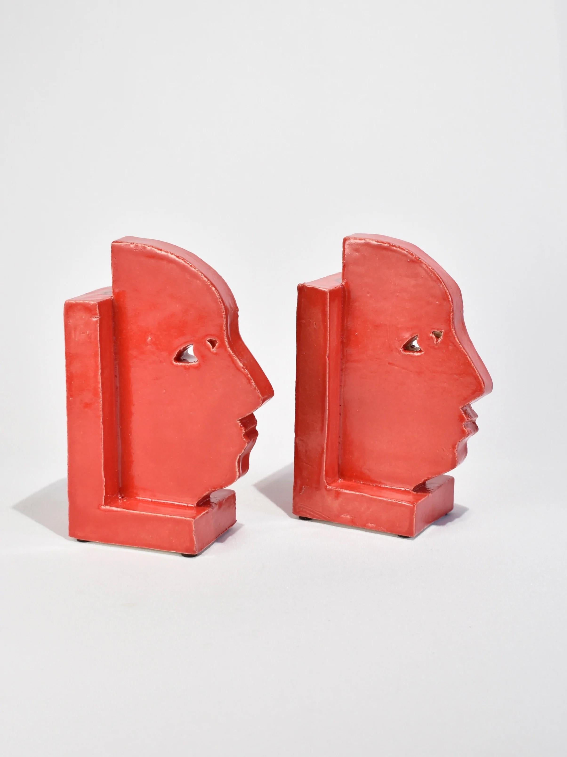 Handmade slab-built bookends with a face profile design in red, set of two. By Shane Gabier, made in NYC.

Please note that this item is handmade and therefore unique; slight variations in color and shape are to be expected.