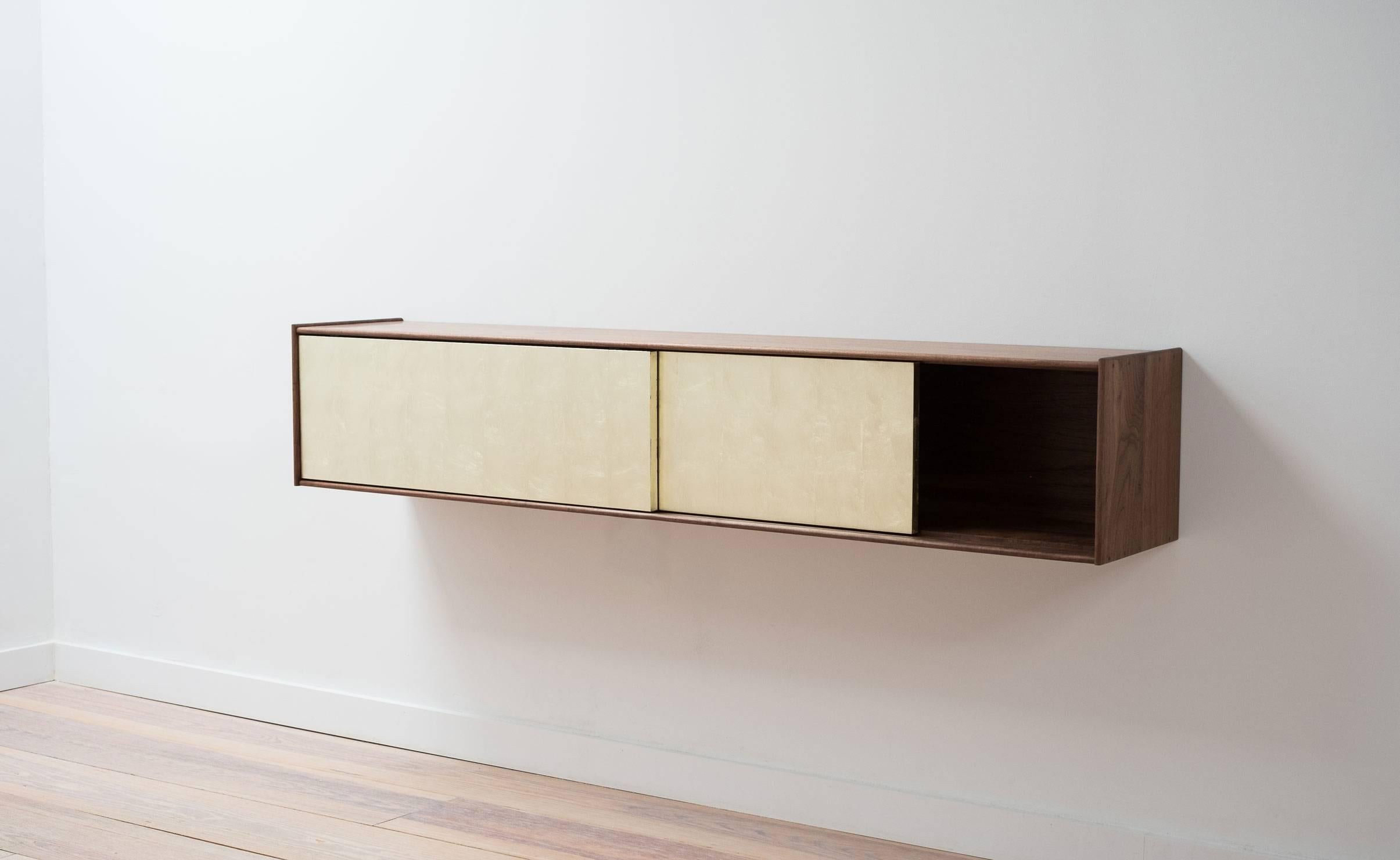 Designed as part of the Profile Case Series, the Profile Console combines the warmth of solid wood with the elegance of gold leaf. The minimal edge profile delicately frames two sliding doors, gilded by hand in 16 karat gold leaf. This piece is