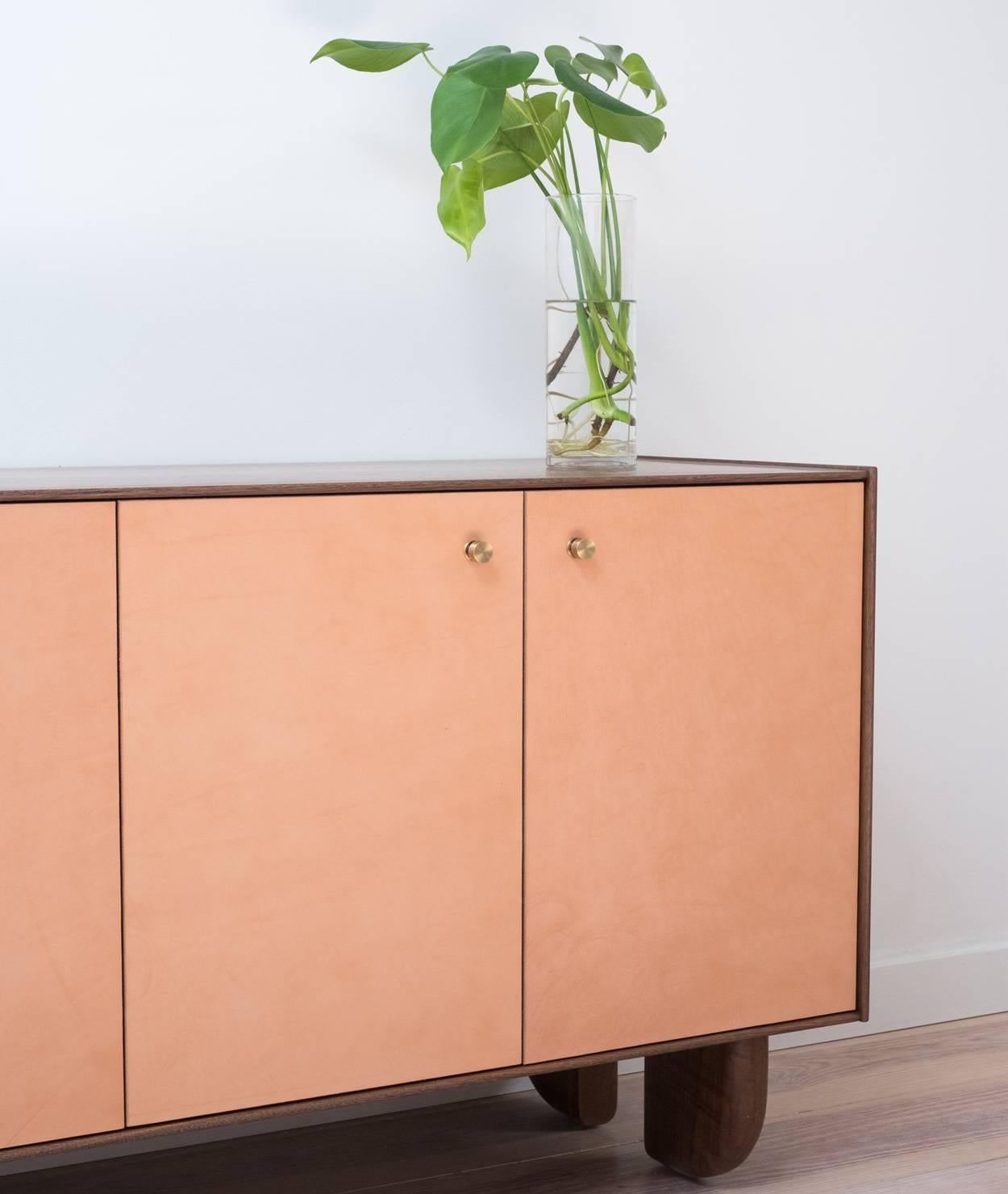 Part of the Profile Cabinetry Series, the Profile Credenza offers an elevated take on traditional cabinet construction. It features a clean, minimal edge in solid black walnut, with doors and drawer faces clad in vegetable-tanned leather. Both the